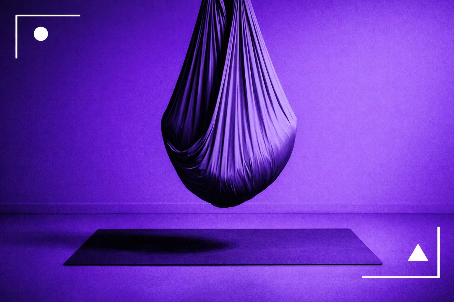 Close-up of aerial silk rigging hardware and carabiner, black-and-white with purple overlay (no people)