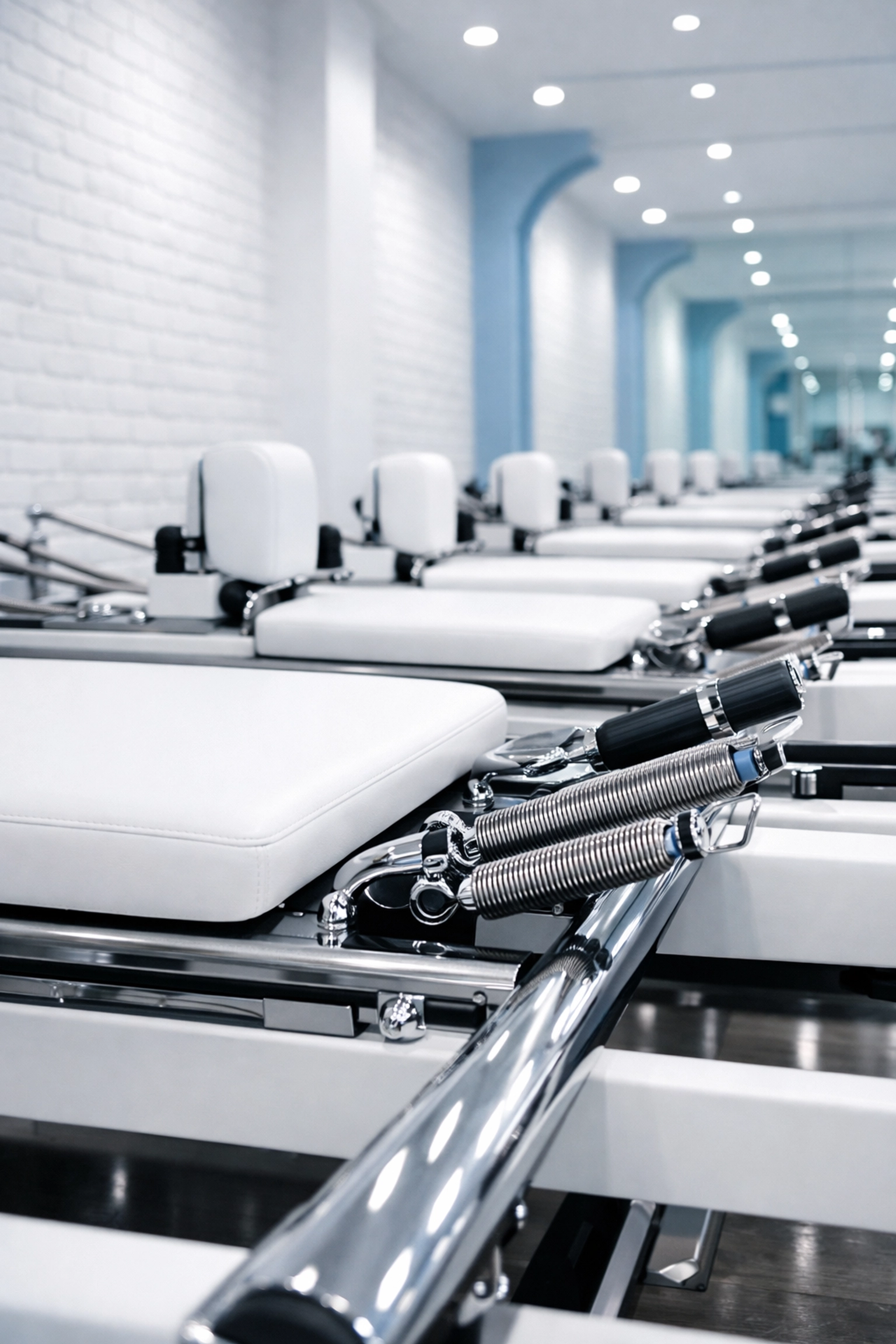 Sanitized Pilates reformers with clean upholstery in a professional Melrose studio.