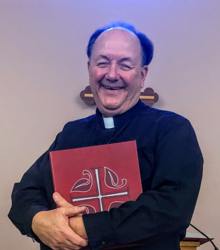 A smiling pastor in clerical attire