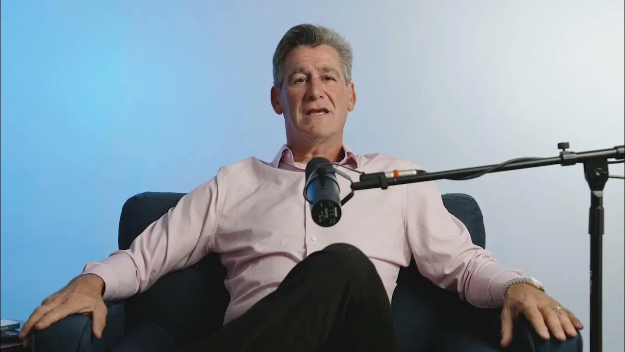 Experienced executive consultant speaking into a microphone in a modern office