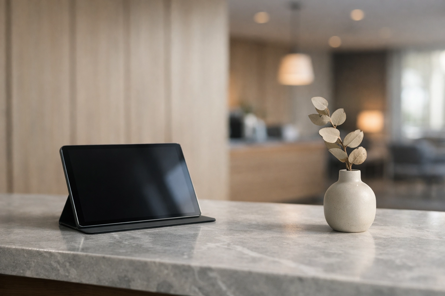 Minimalist hotel reception desk with a tablet for modern guest experience technology.