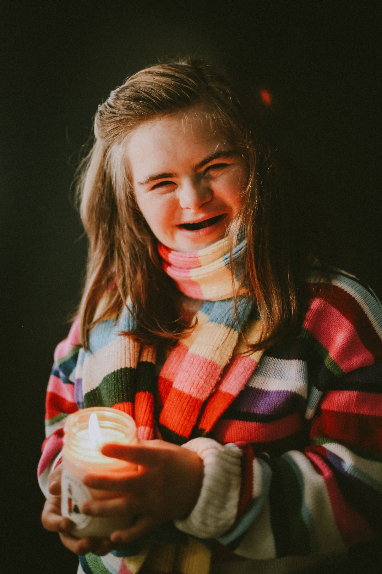 Smiling Woman Holding Hand-Poured Candle