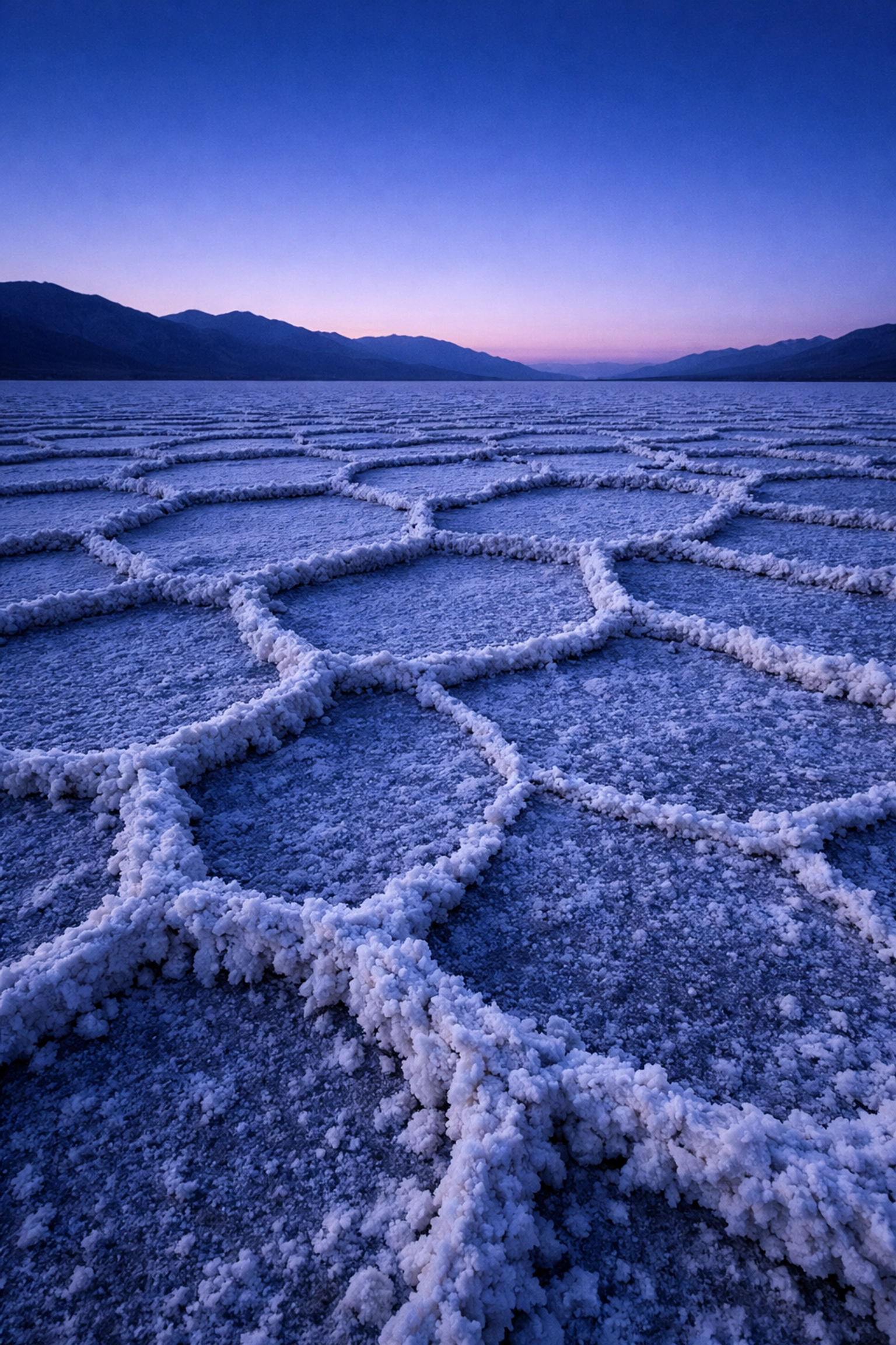 Hexagonal salt patterns at Badwater Basin in Death Valley National Park, a unique photography location.