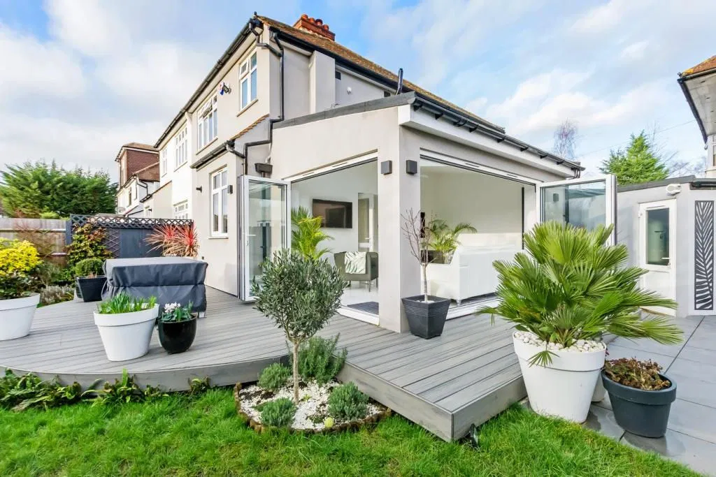 Contemporary rear extension with bi-fold doors and composite decking