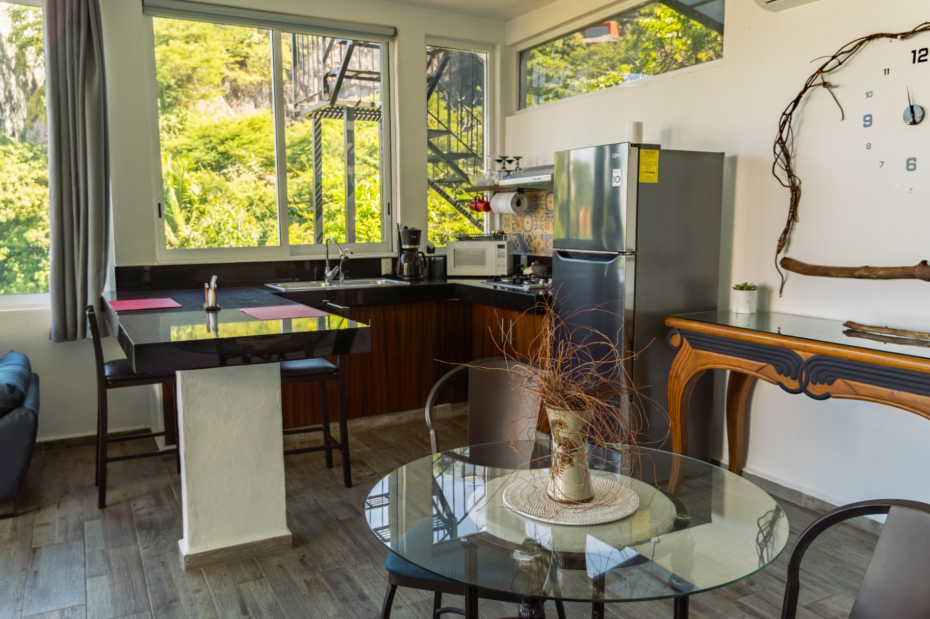 Modern condo kitchen and dining area with greenery views