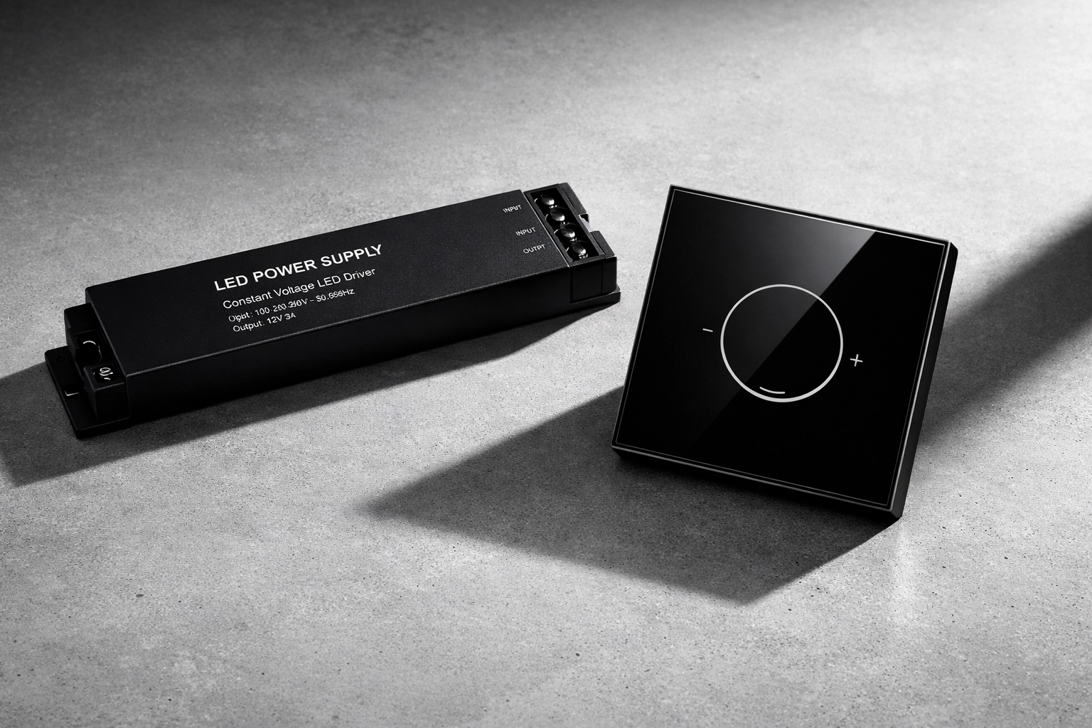 Professional matte black LED power driver and modern glass touch-dimmer switch.
