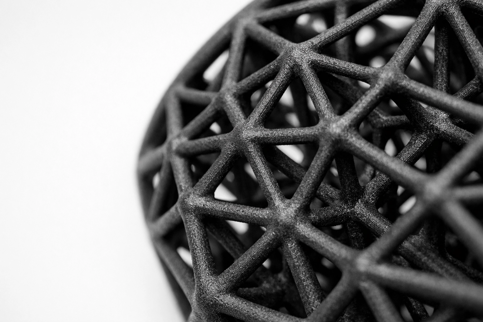 Close-up of a complex MJF 3D printed lattice structure for lightweight mechanical parts. Close-up of a complex MJF 3D printed lattice structure for lightweight mechanical parts.