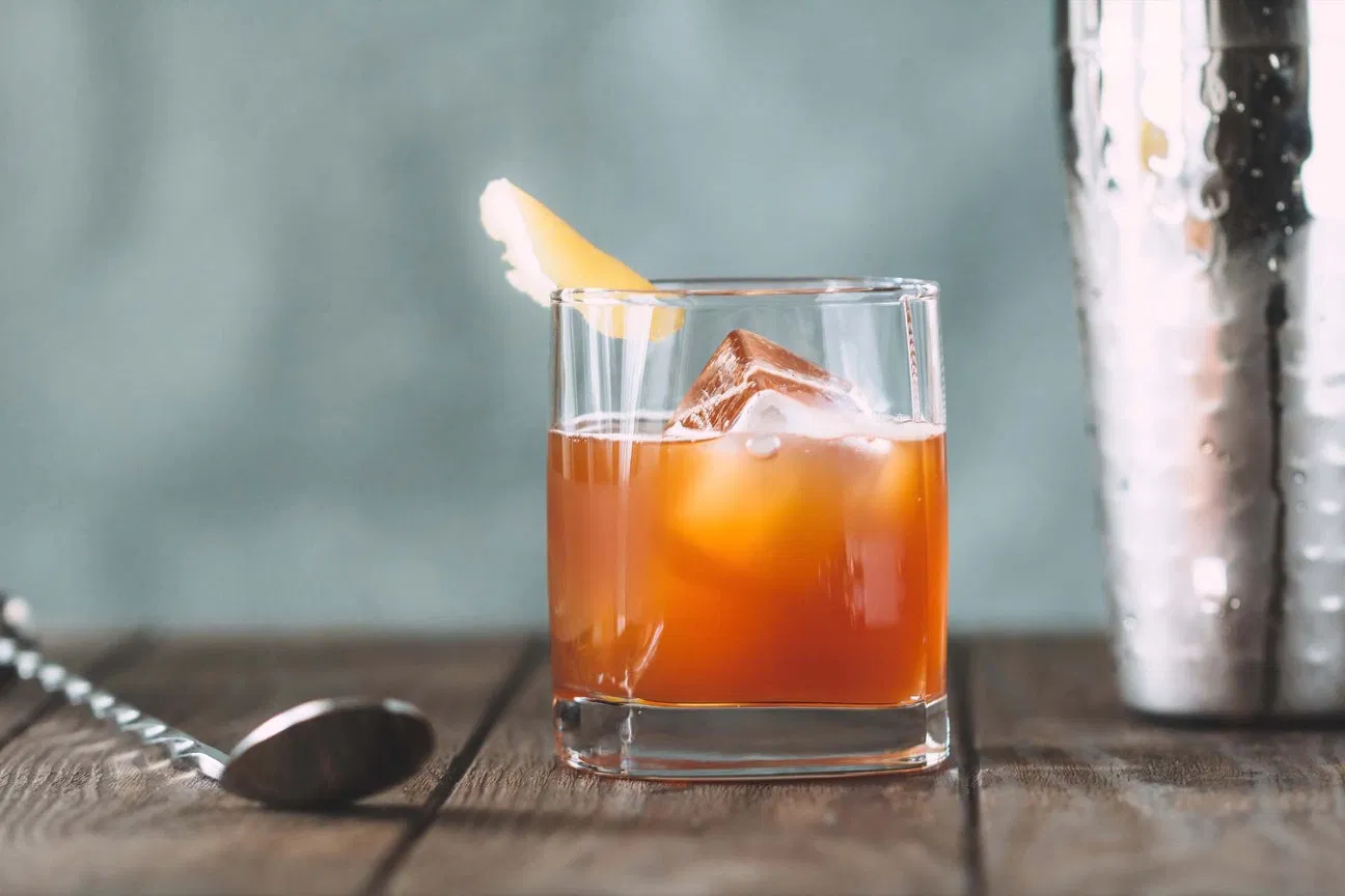 A classic Negroni-inspired cocktail prepared with Tiny Bear Distillery gin, served over large ice cubes.