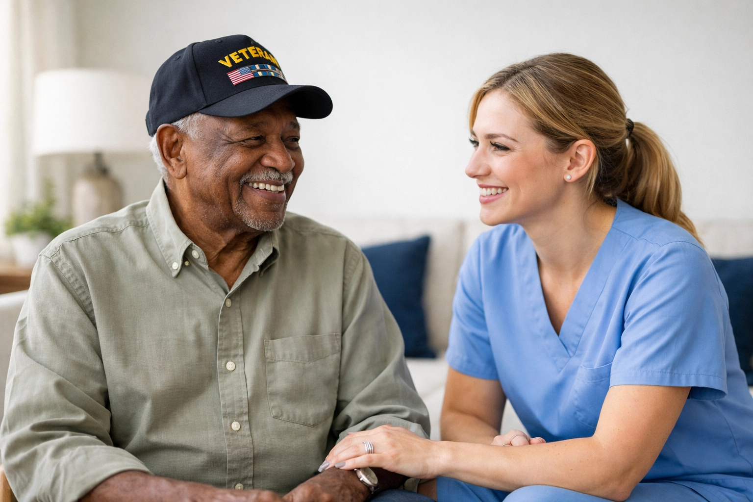 Caregiver and veteran in Manassas discuss VA Aid and Attendance home care options in a bright living room.