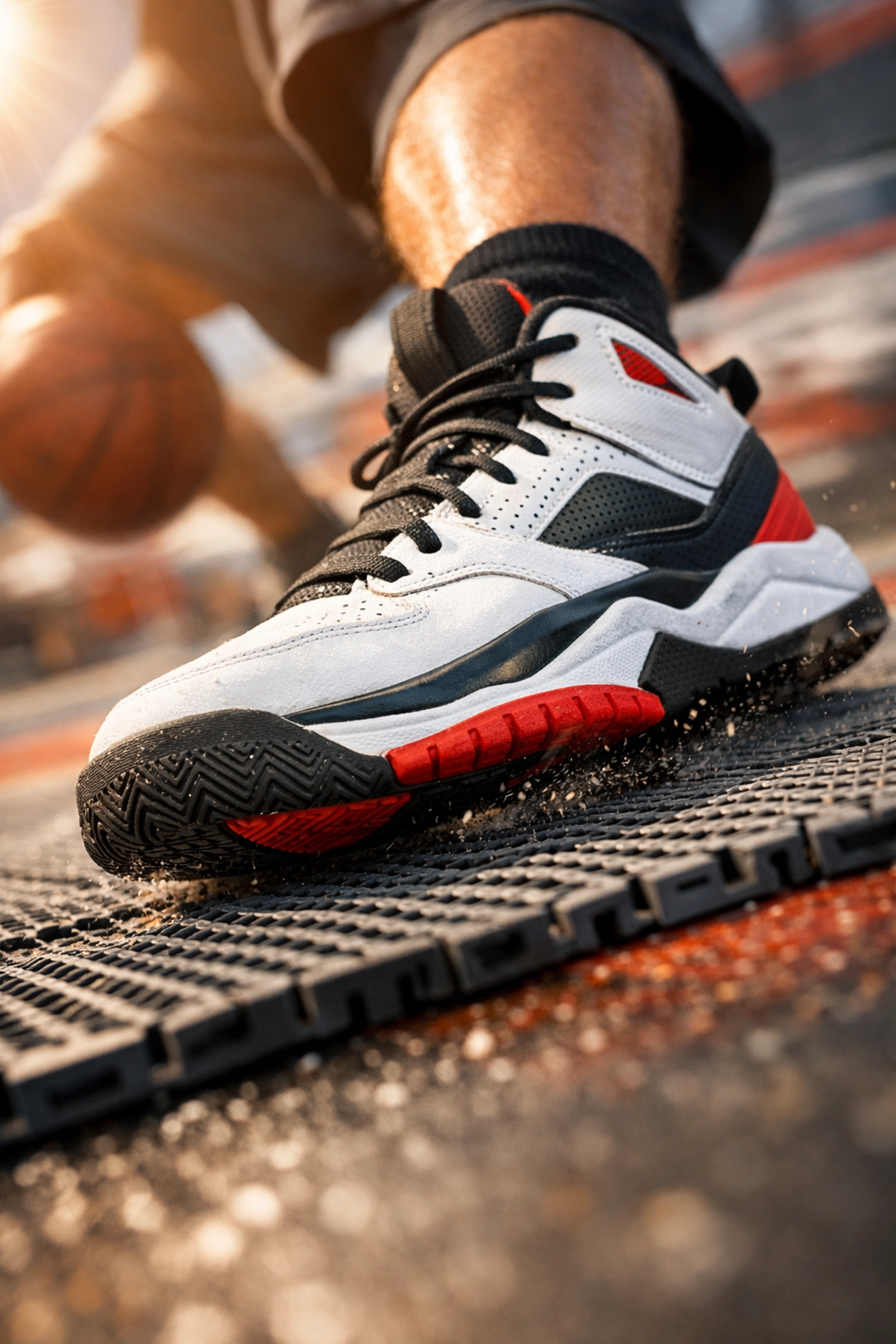 Close-up of a basketball shoe showing grip and shock absorption on a high-performance modular court surface.