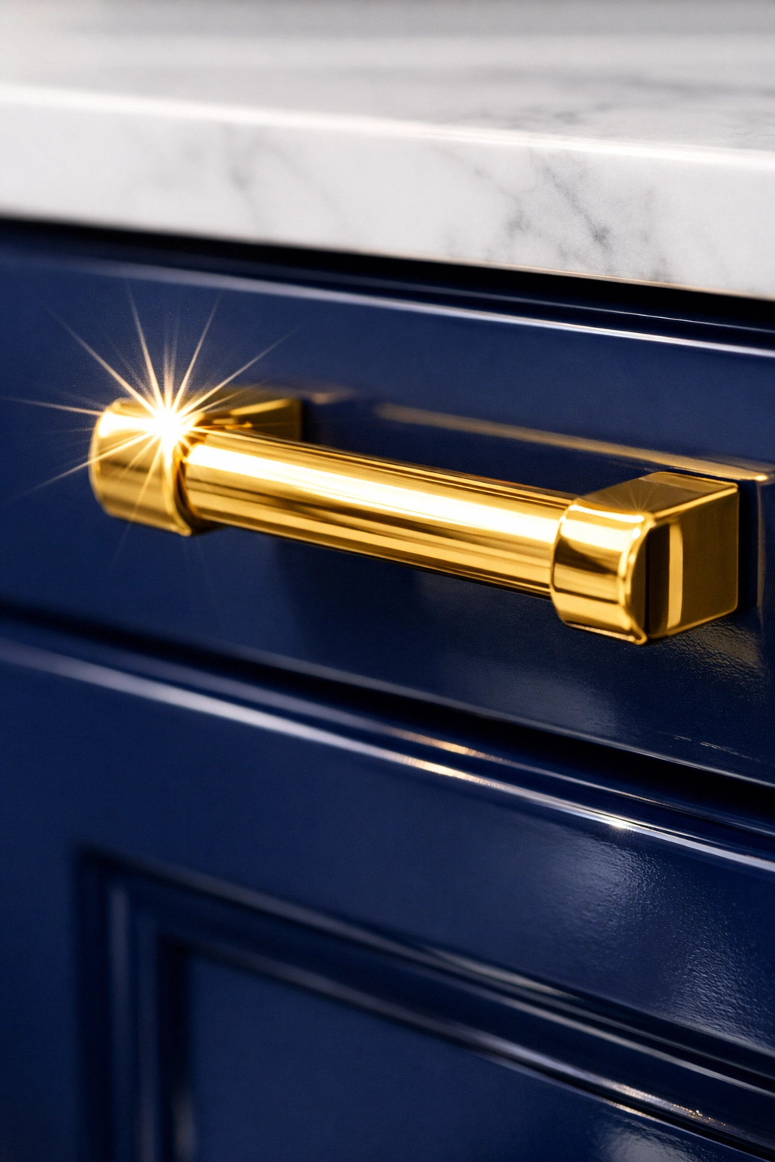 Detailed close-up of a spotless gold handle and navy vanity in a luxury Needham estate bathroom.