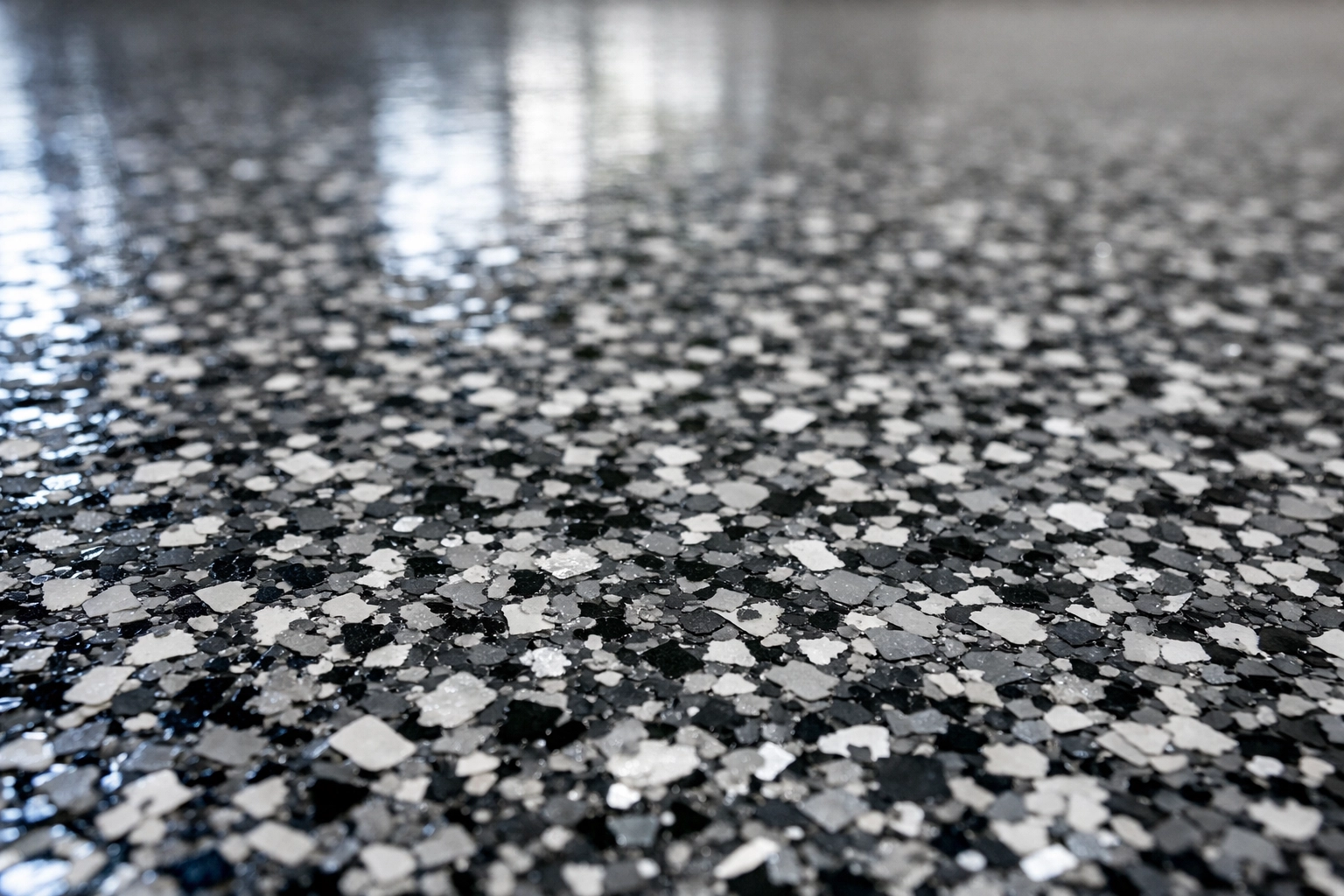 Close-up of polymer flake flooring in a Ridgeland MS garage floor upgrade with glossy finish
