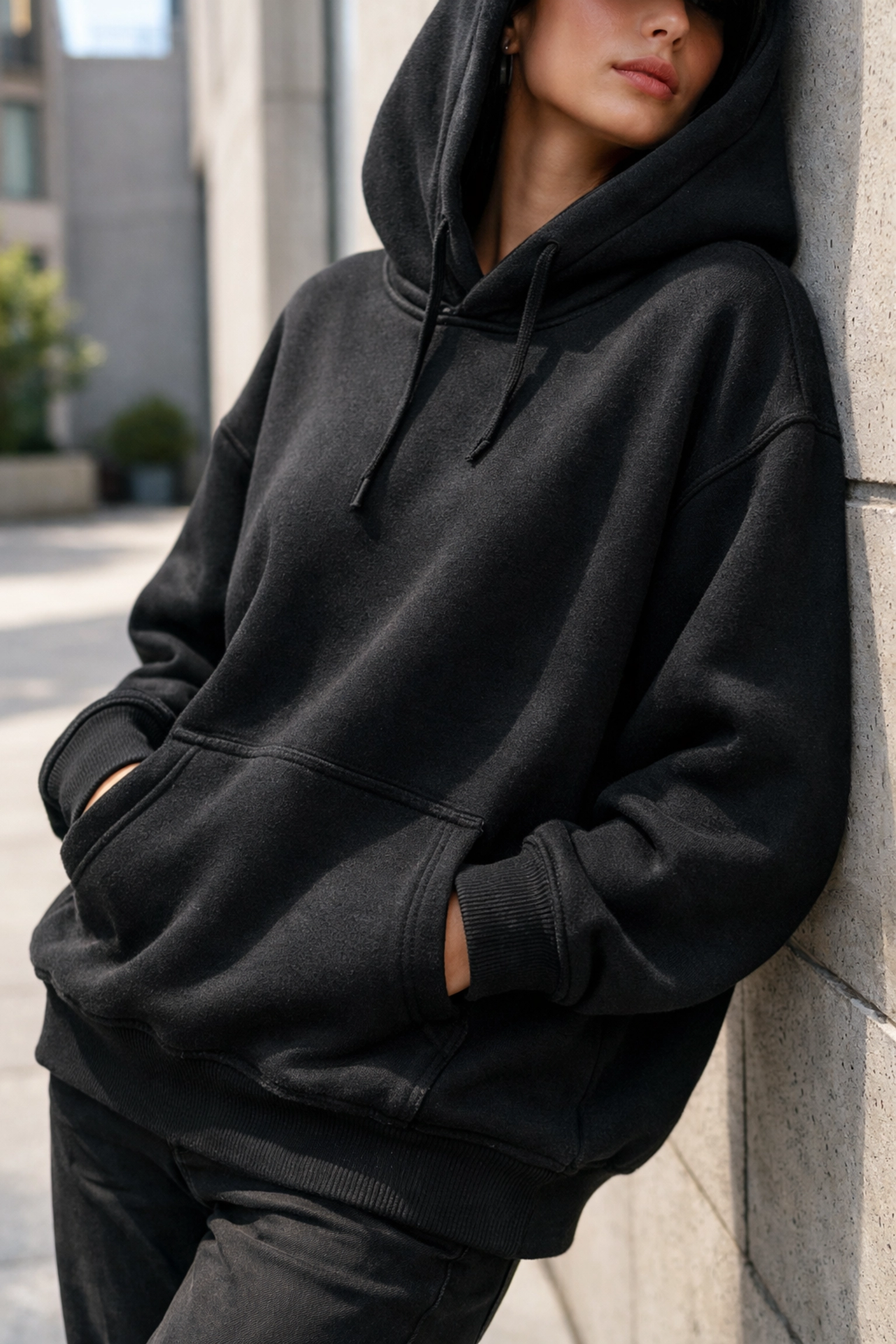 Artist modeling a high-quality brand hoodie for a streetwear collaboration lifestyle photo.