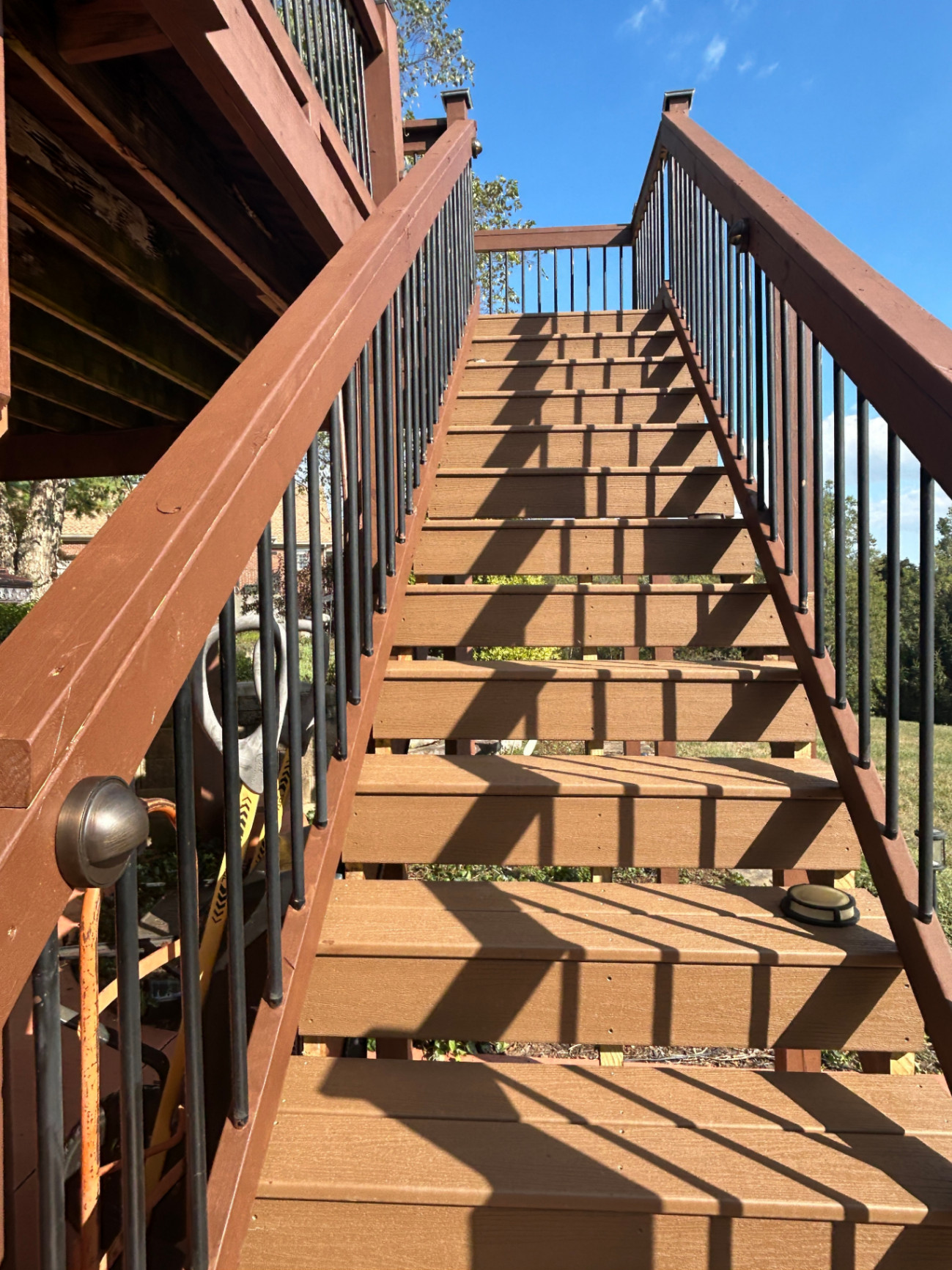 Discreet step lighting on a wooden staircase enhances safety without visible wires