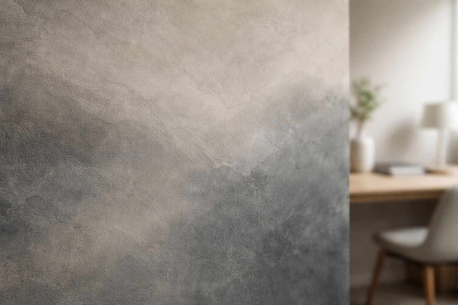 Chalky two-tone matte plaster wall detail highlighting color transitions and texture in a home office.