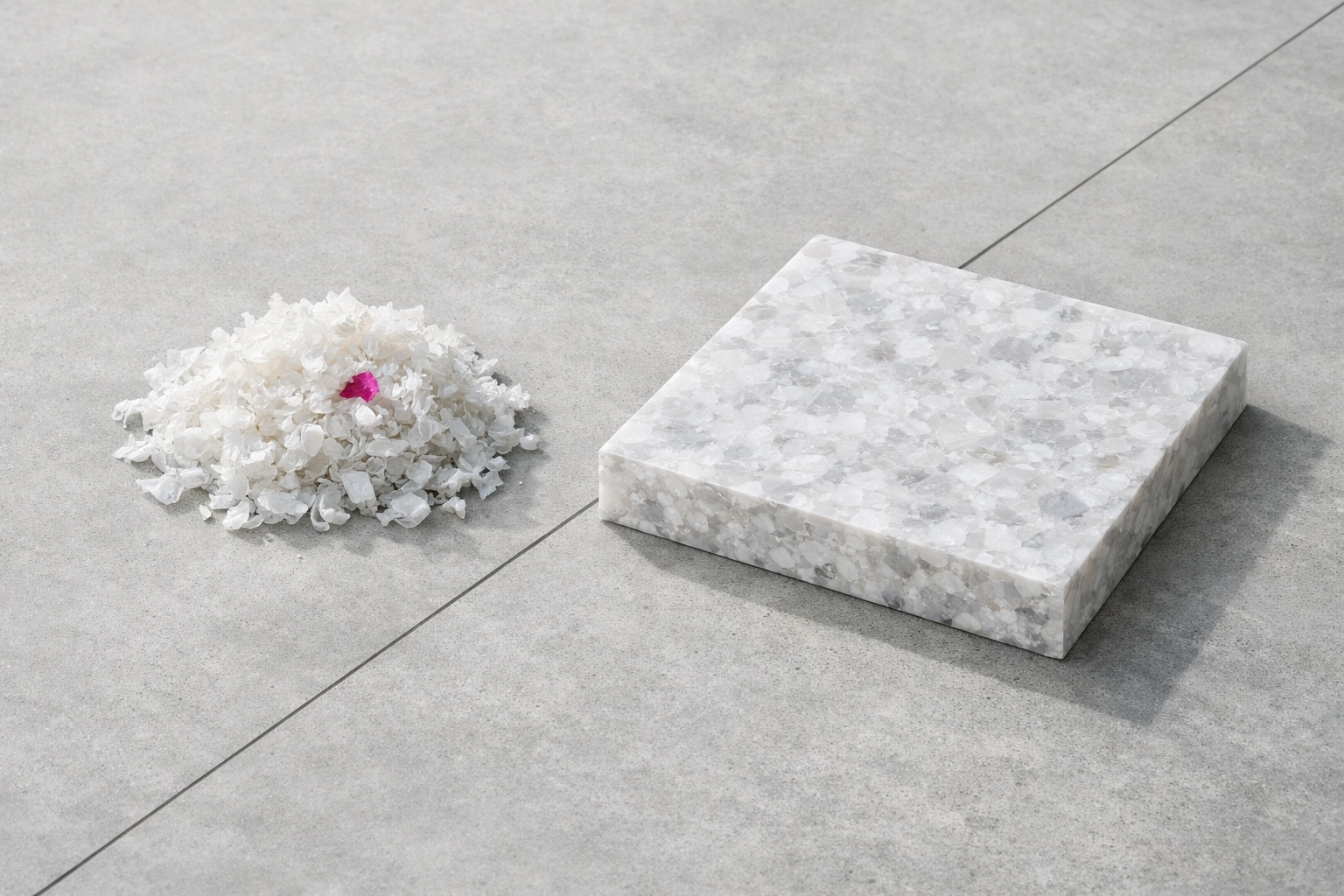 Australian plastic waste shreds next to a finished 100% recycled plastic architectural panel.