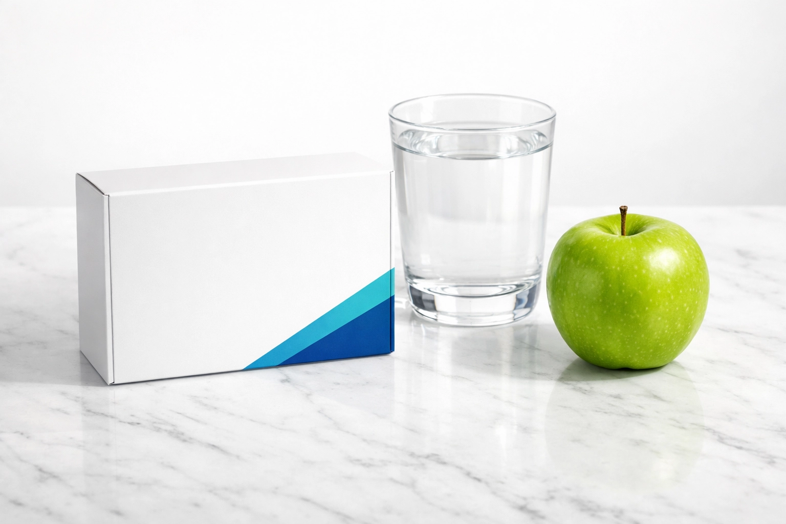 Prescription weight loss medication delivery package next to a healthy green apple and water.
