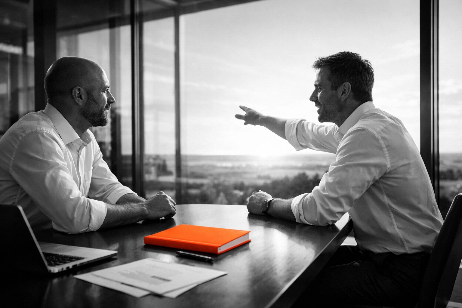 Business advisors discussing exit planning and the owner's next chapter in a modern office.