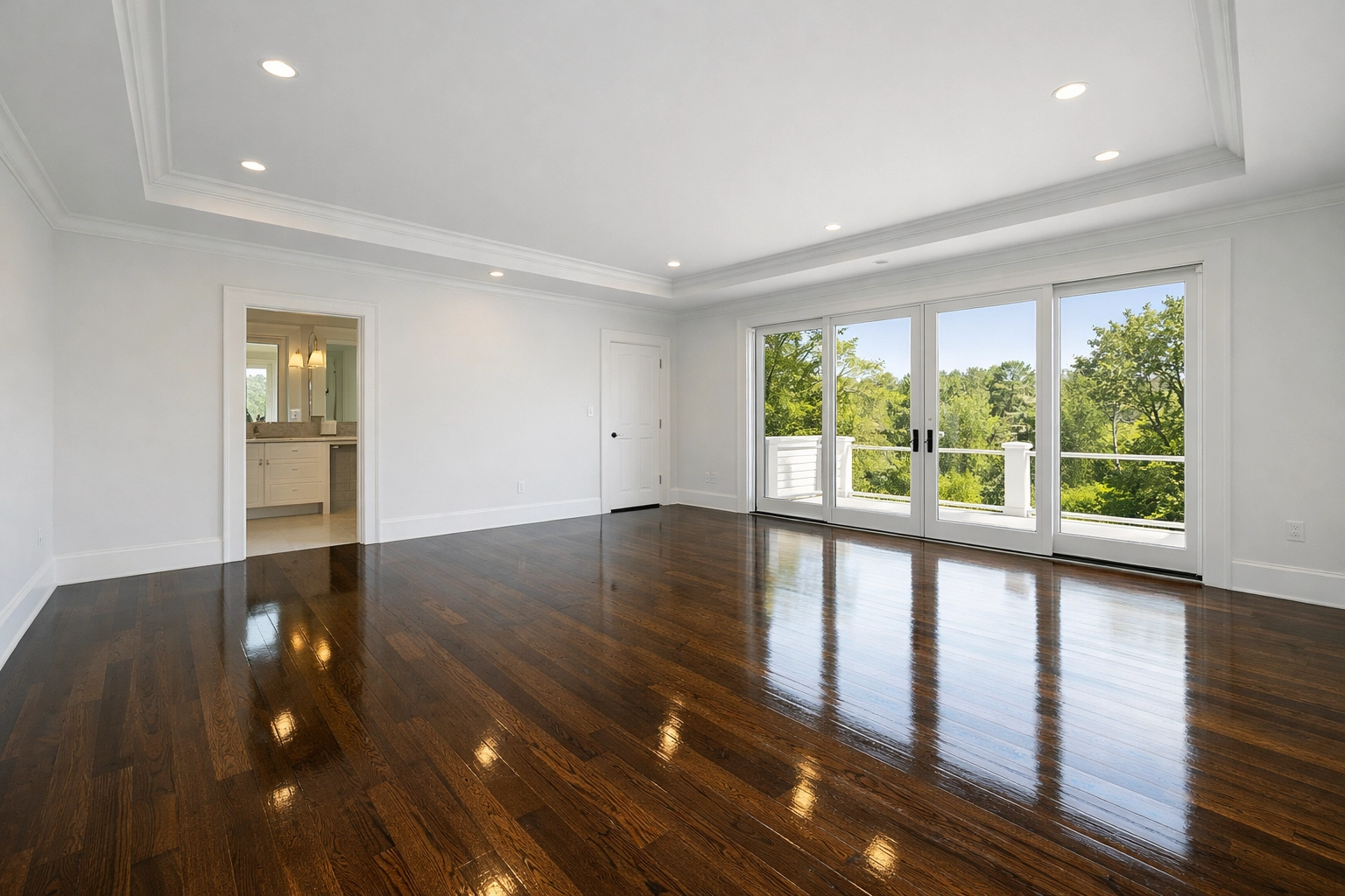 Professionally cleaned master bedroom suite with gleaming hardwood floors and large windows in Barnstable, MA.