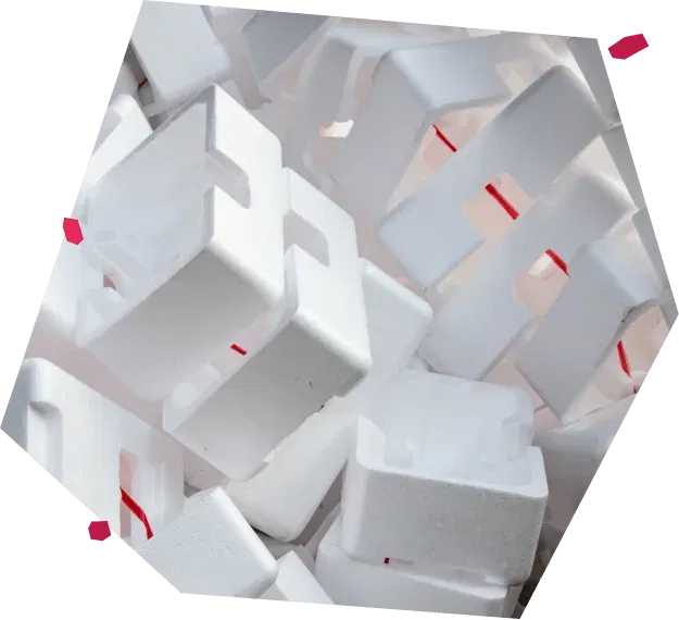 A collection of used expanded polystyrene packaging blocks, typically discarded after product shipping, which Resourceful Living transforms into durable, fully recyclable plastic panels.