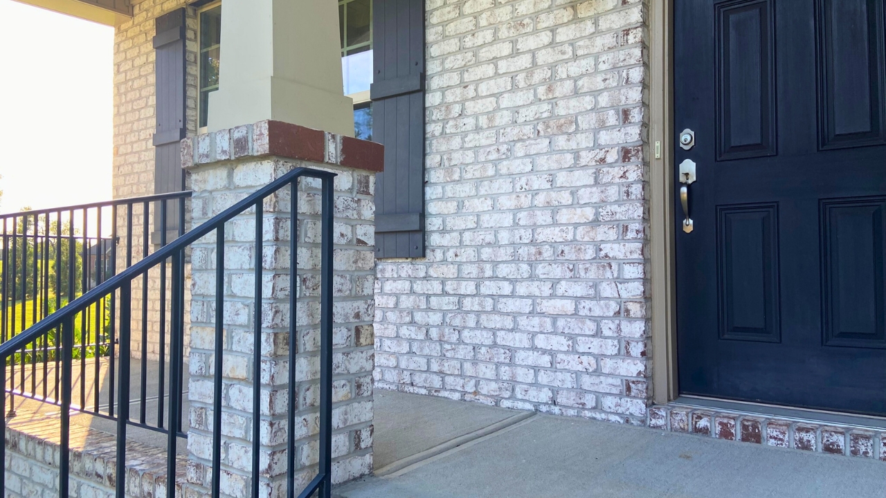 Front Porch with Painted Brick and Black Door