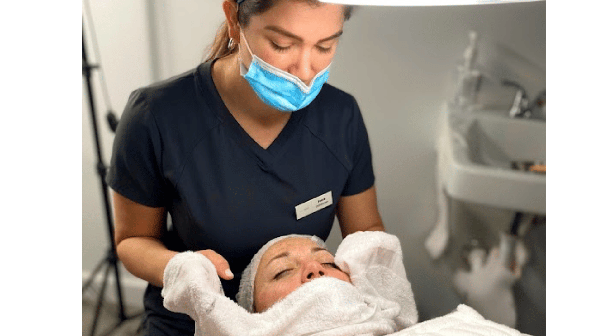 A client receiving a rejuvenating facial treatment in a relaxing clinic setting