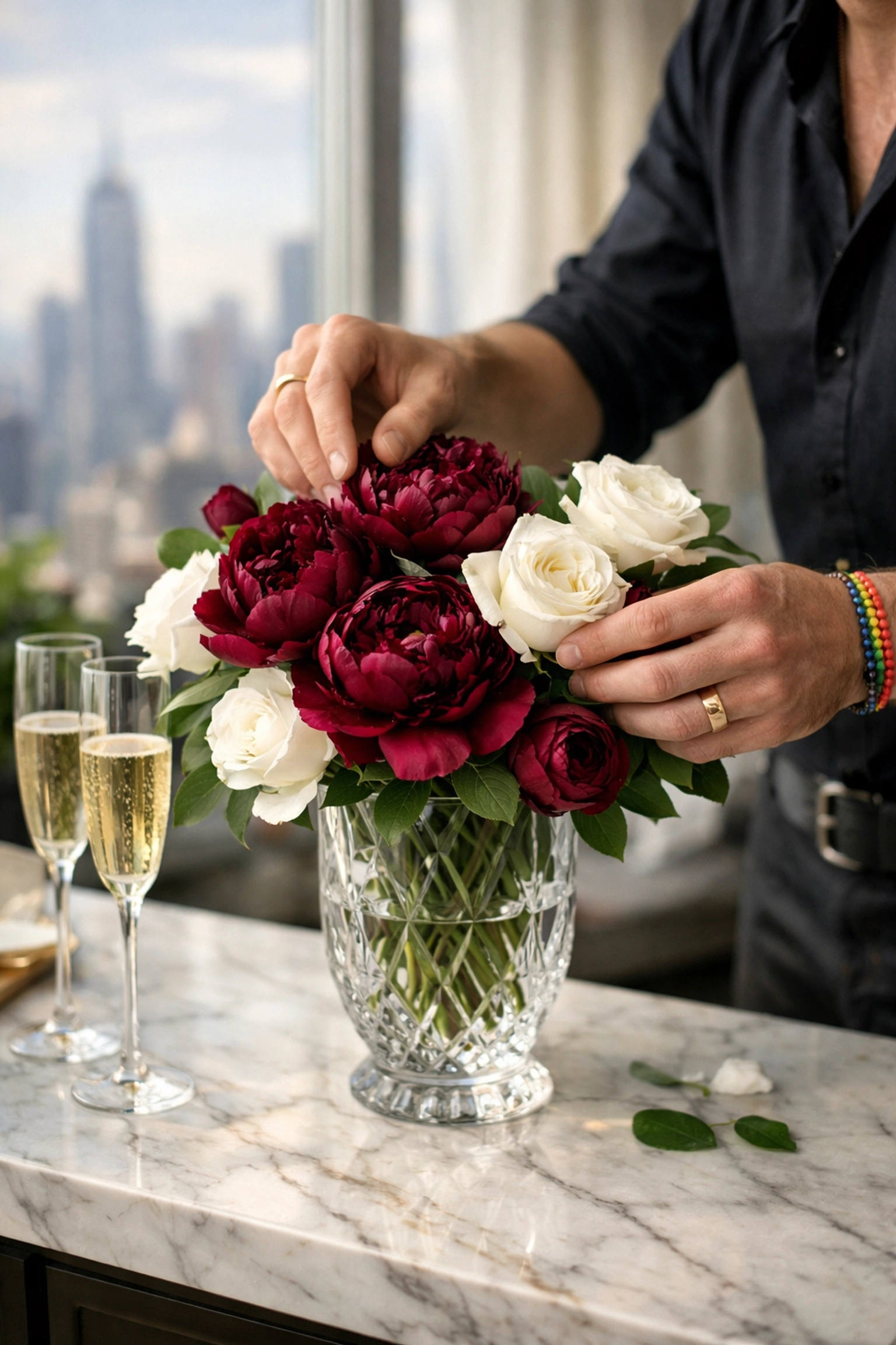 Luxury gay florist arranging peonies and roses in high-end penthouse setting