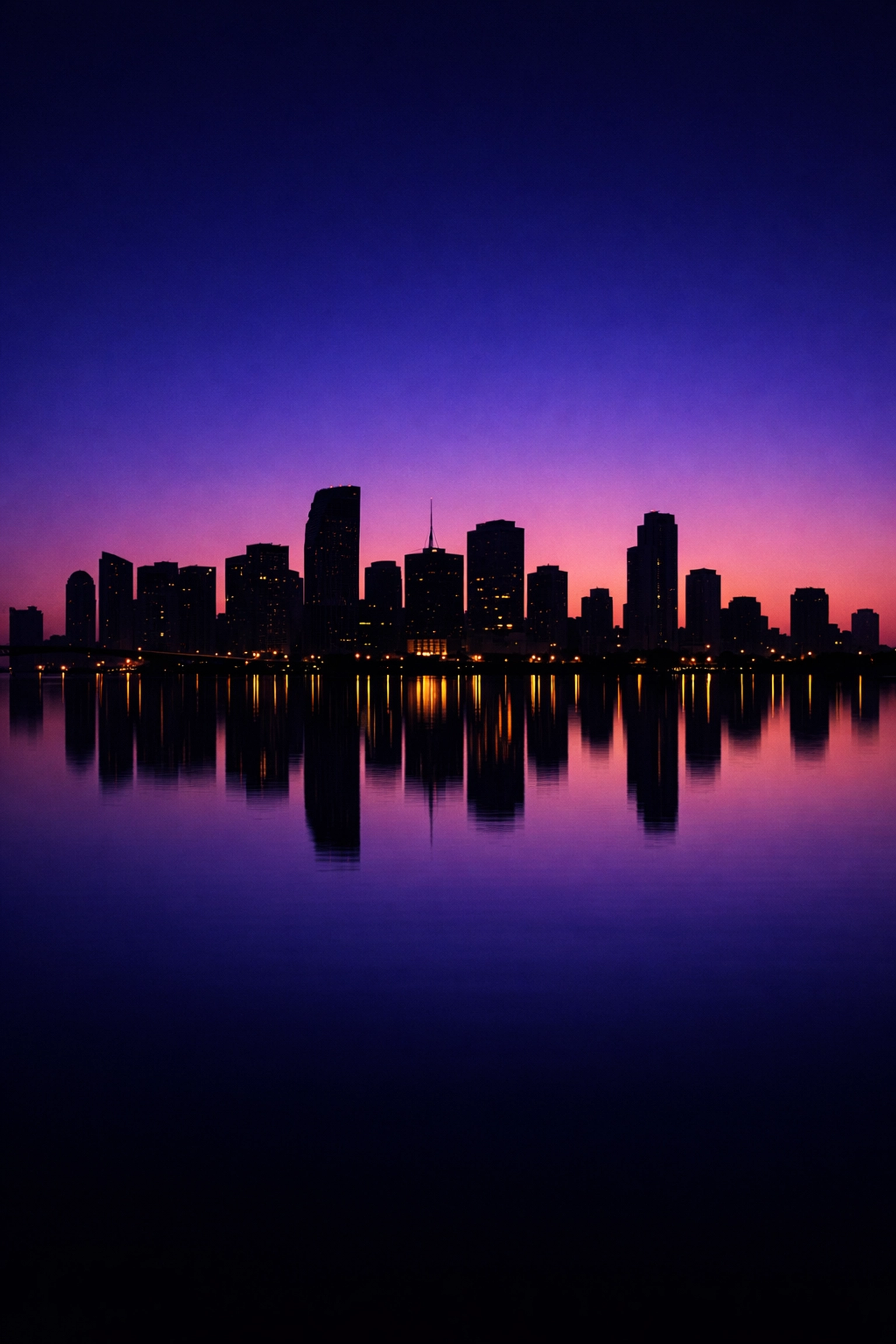 Cinematic Miami skyline at twilight reflecting in water, perfect for event photography backdrops.