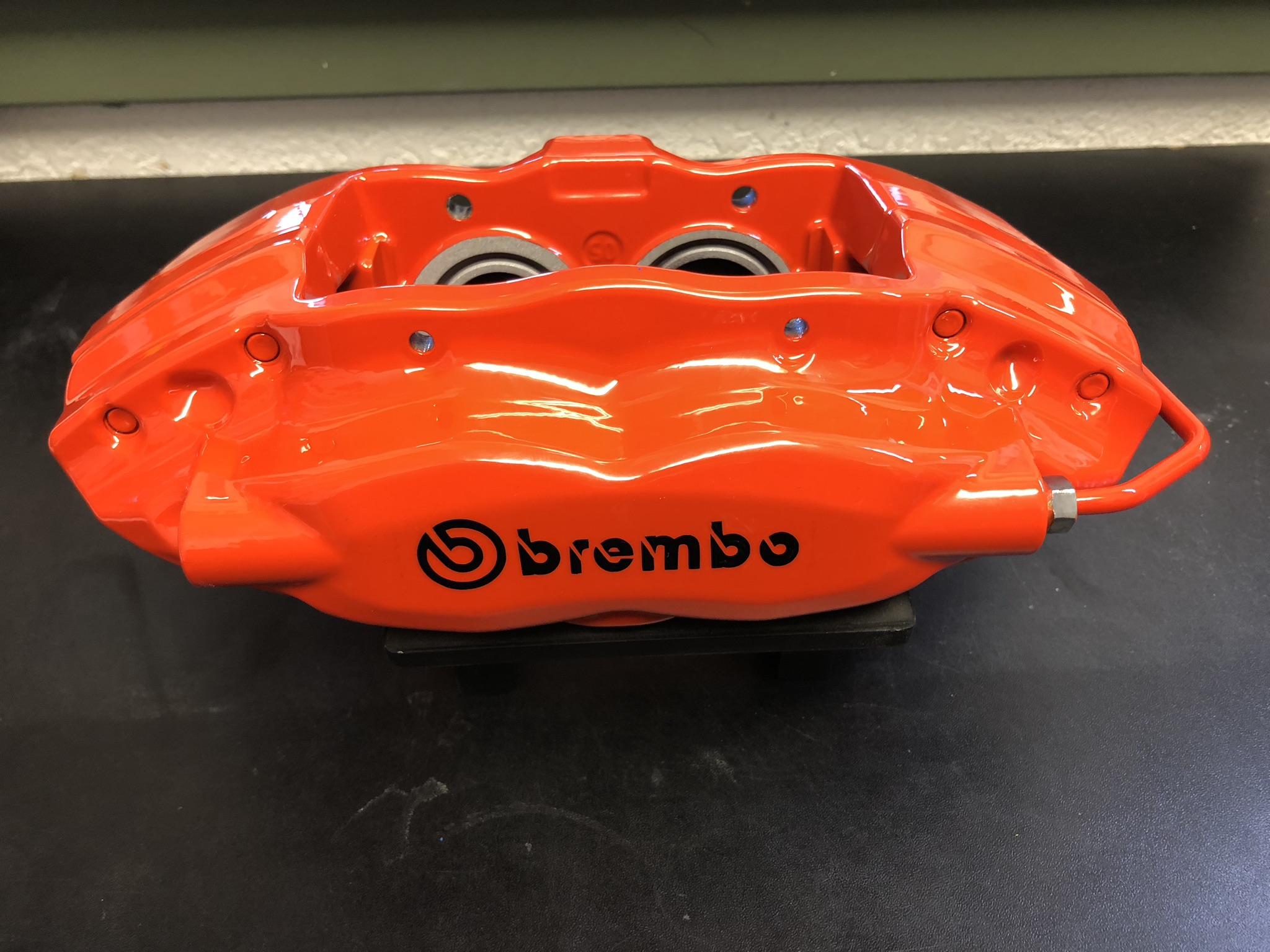 New brake pads being inspected during Brembo caliper powder coating service