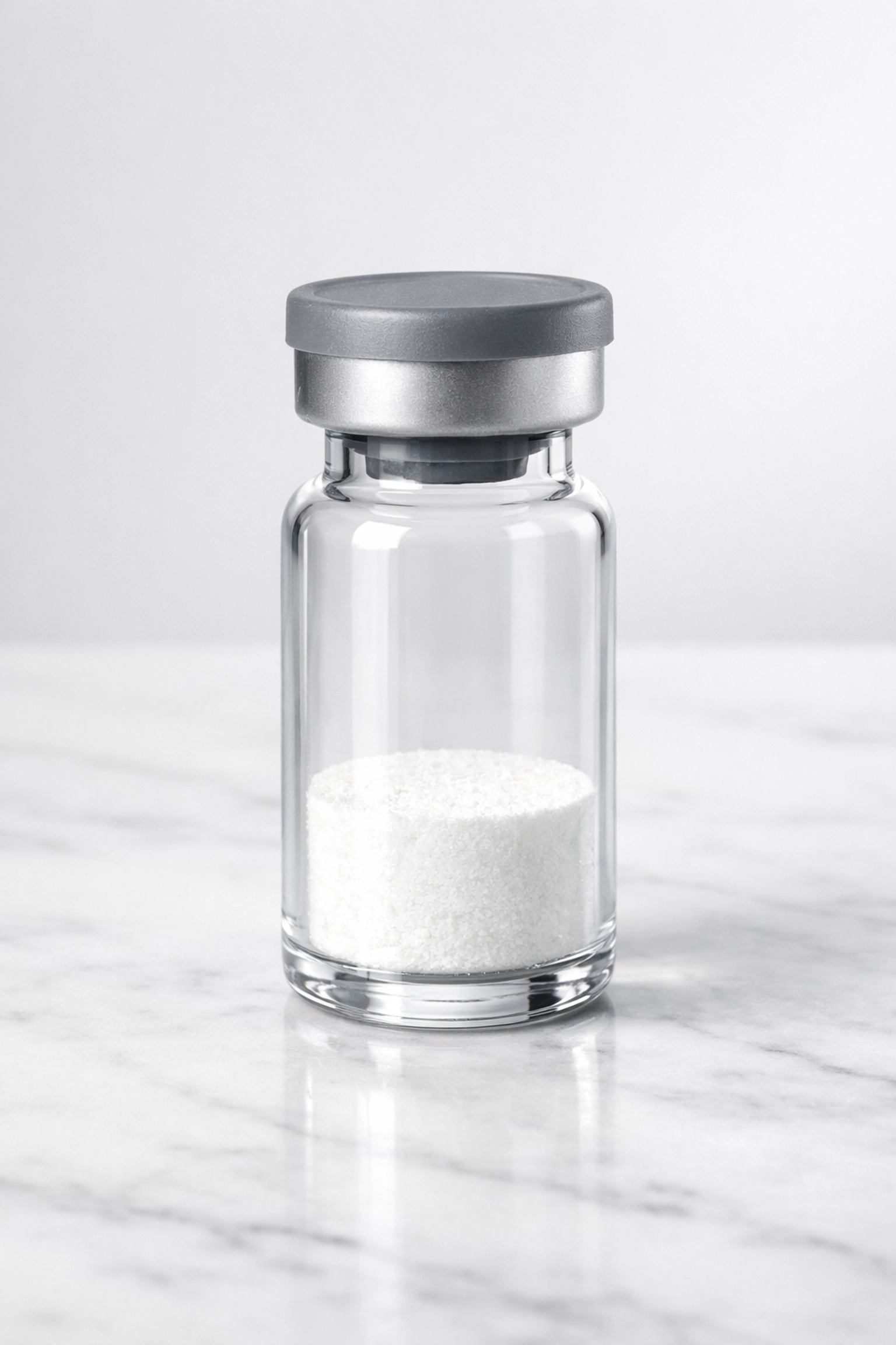 Glass vial of ACTH 1-39 peptide on a marble surface for neuronal health research.