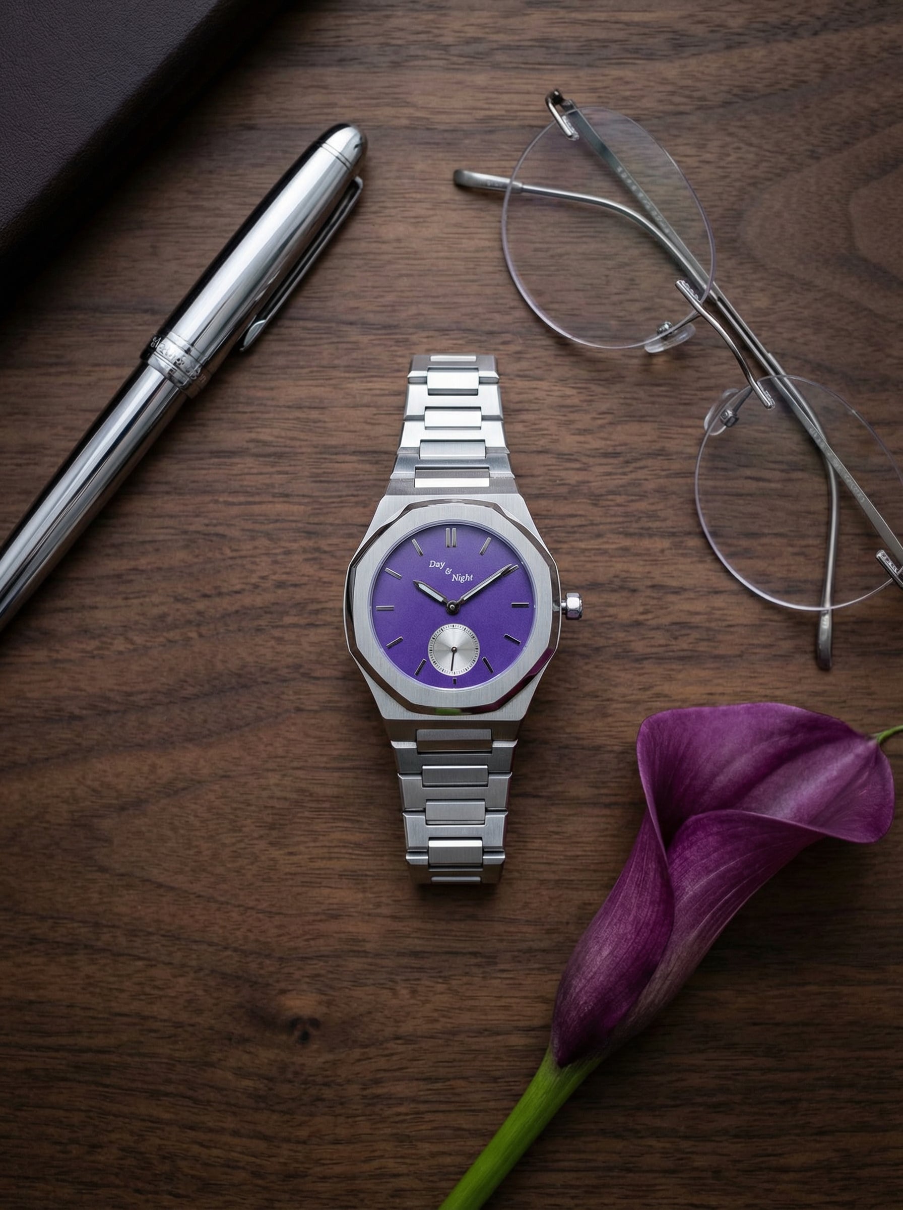The Hatshepsut lilac purple dial watch from the Queen Pharaoh Collection beside a calla lily