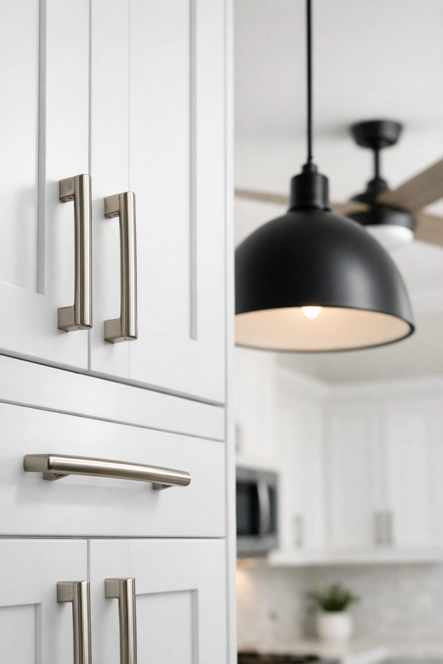 Modern kitchen fixtures including brushed nickel hardware and pendant lights that increase home resale value
