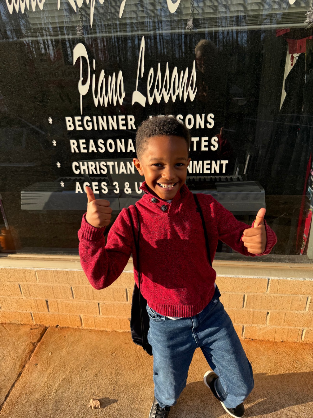 A young student in front of Piano Keys for Christ