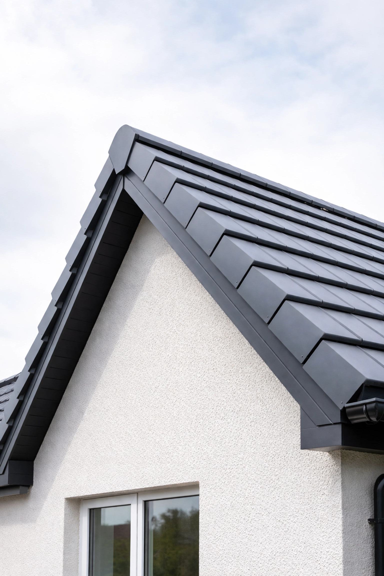 Low-angle view of a home in Northern Ireland with modern dry verge caps securing roof edges for added weather protection