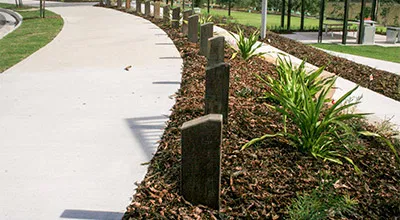 Durable garden edging panels made from 100% recycled Australian plastic waste installed along a landscaped pathway