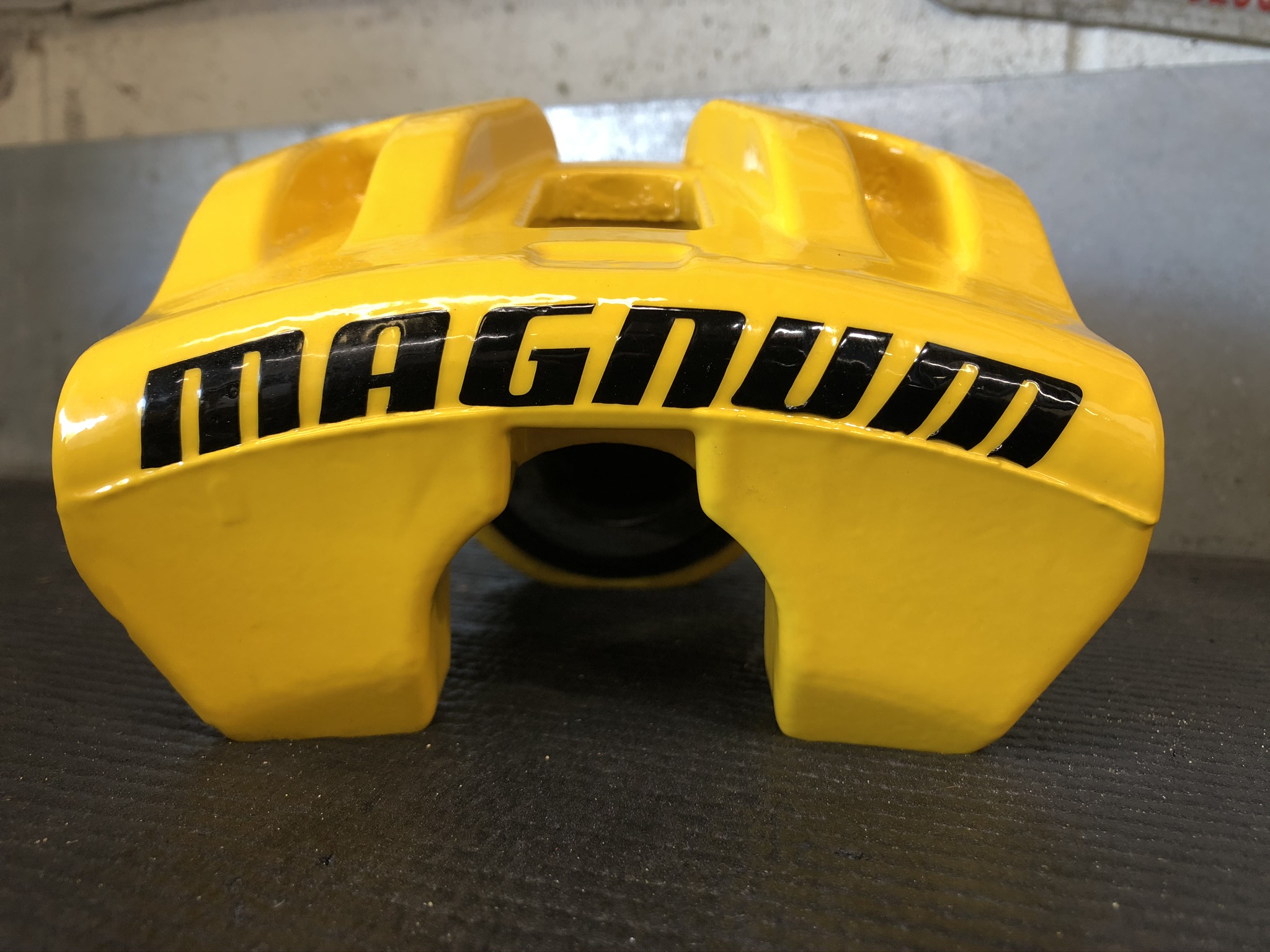 Single-piston // Bright yellow powder-coated brake caliper for Dodge Magnum with a high-gloss finish, featuring a bold black 