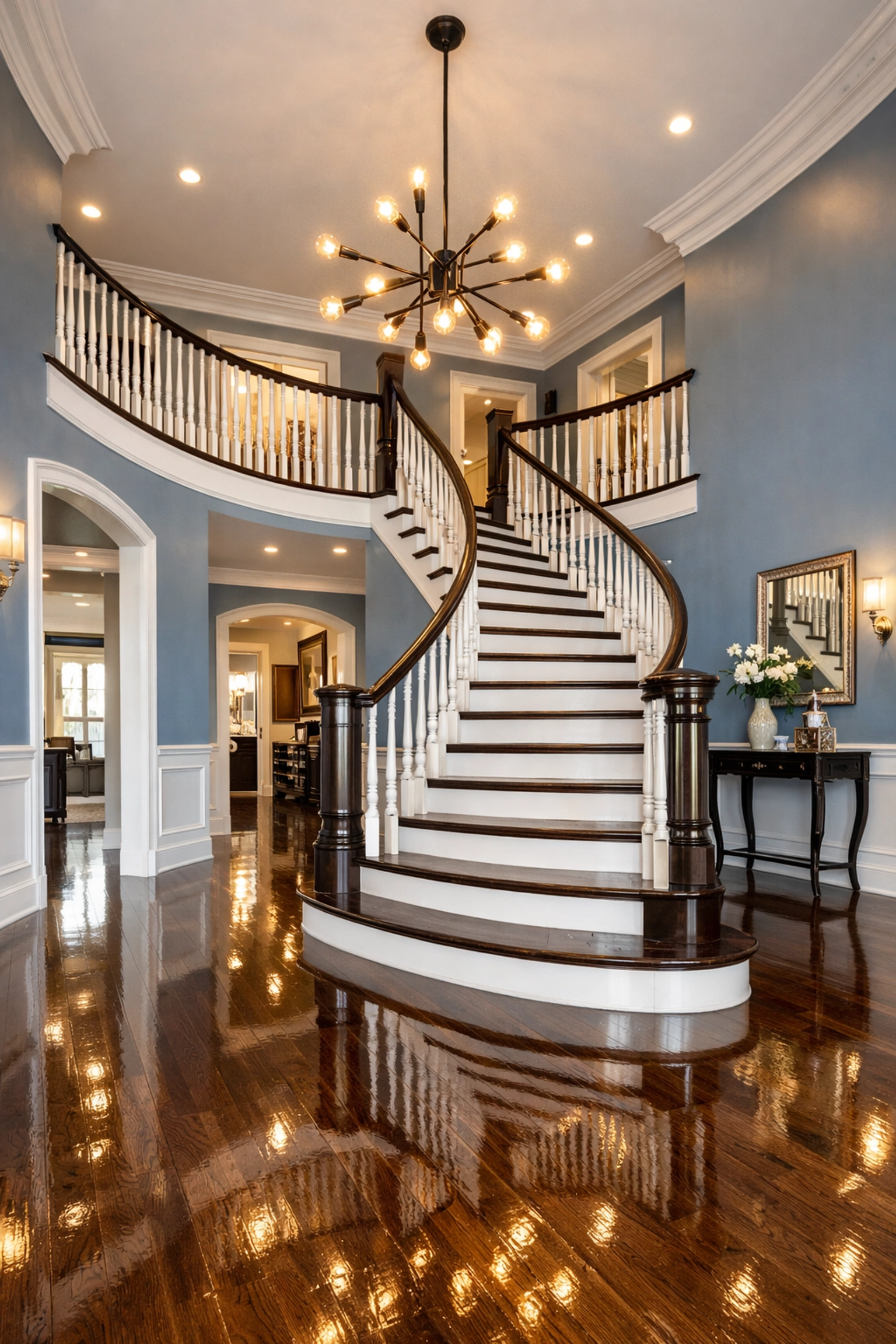 Polished grand foyer of a luxury Carlisle custom home with a staircase and high-gloss floors.