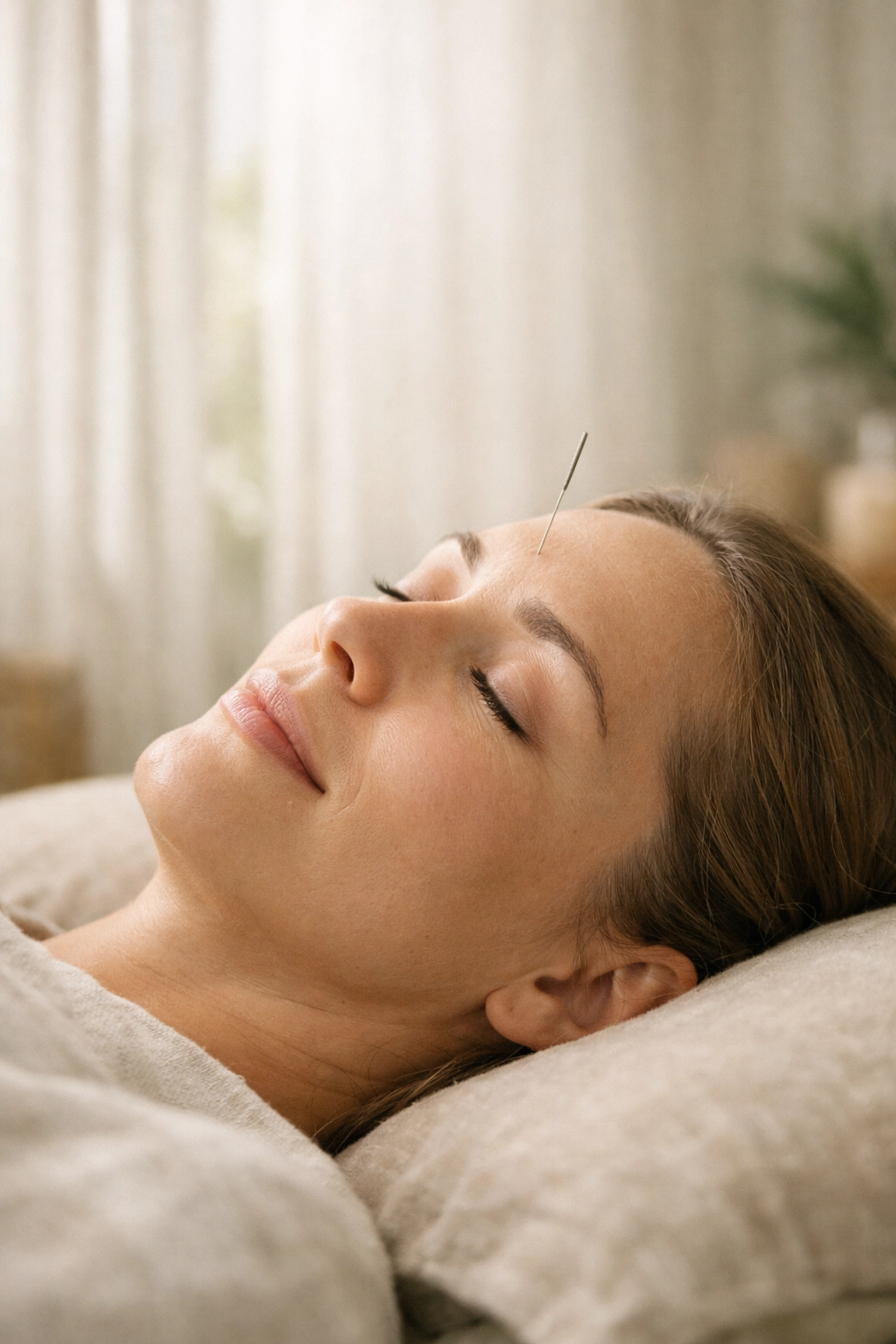 Relaxed person receiving acupuncture in St. Pete to shift the body from survival mode to healing mode.