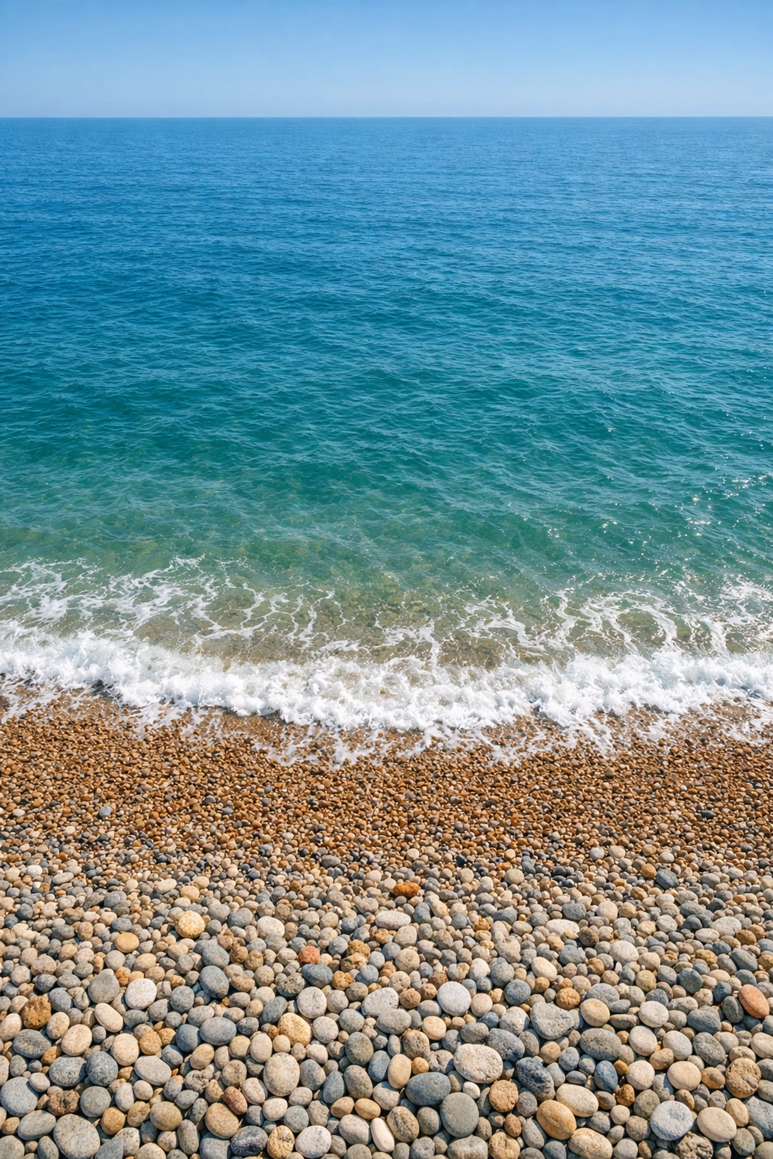 Aerial view of Brighton Beach pebbles meeting the English Channel waters