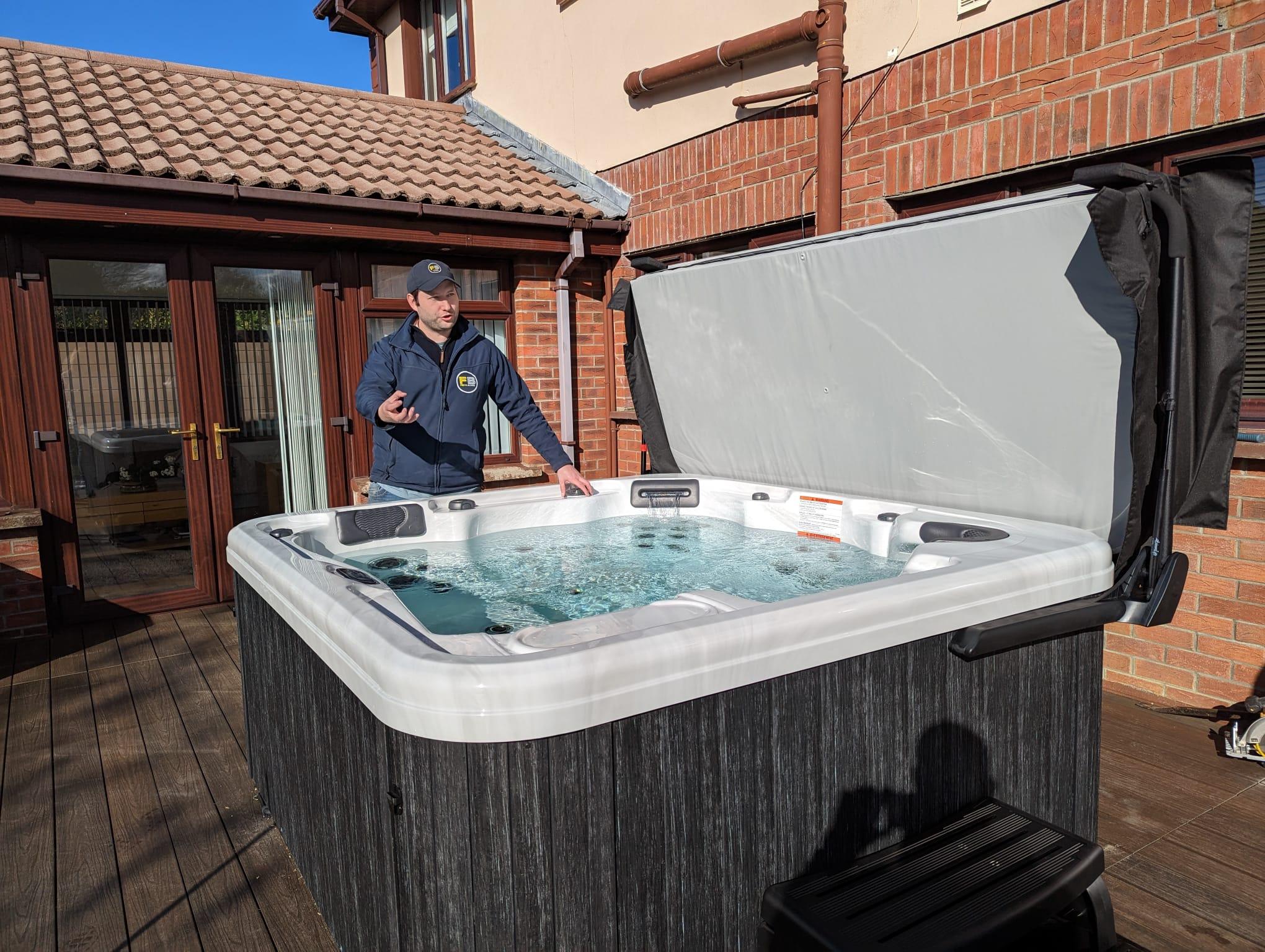 fiesta-spas-technician-demonstrating-artesian-hot-tub-garden.jpg