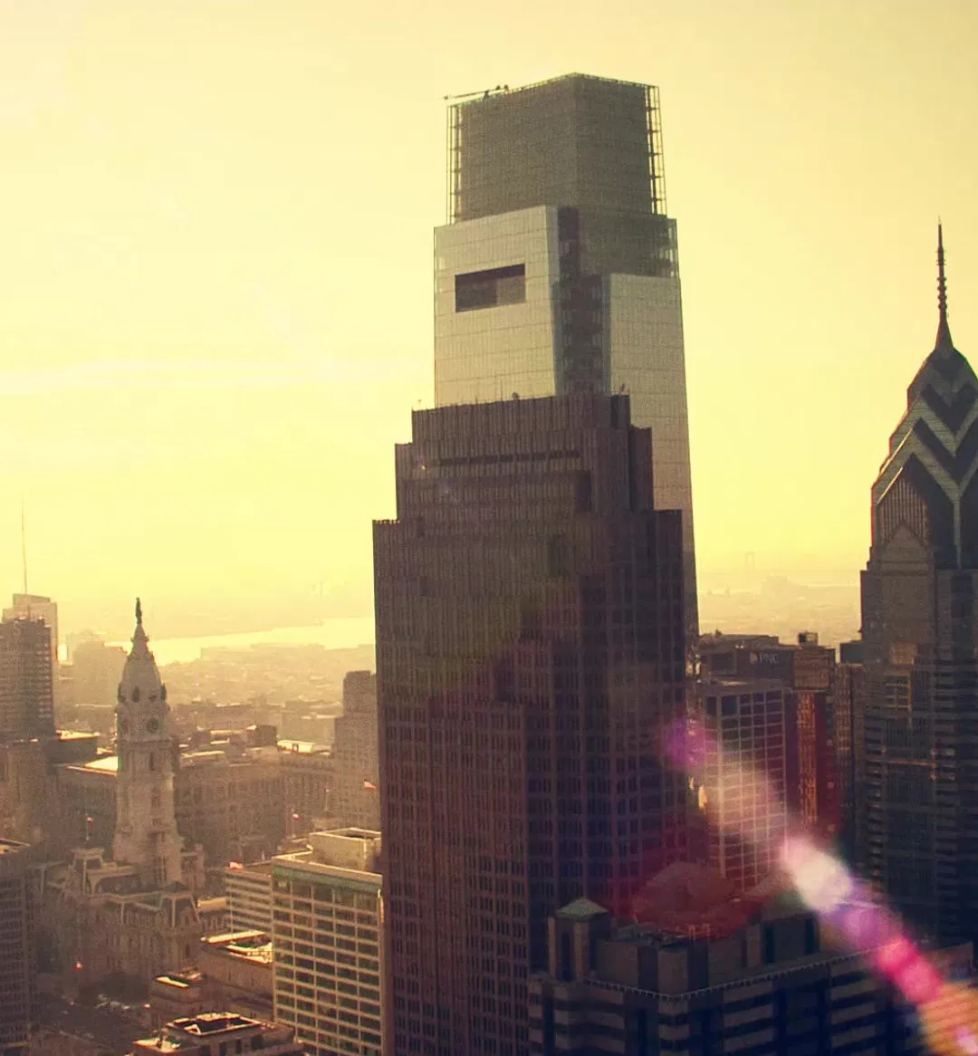 Downtown city skyline at sunrise, featuring high-rise commercial buildings with optimal solar exposure.