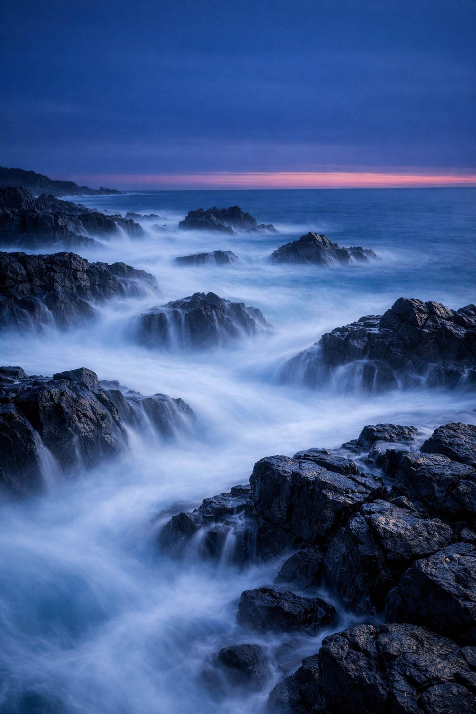 Long exposure seascape with misty water around basalt rocks: landscape photography technique
