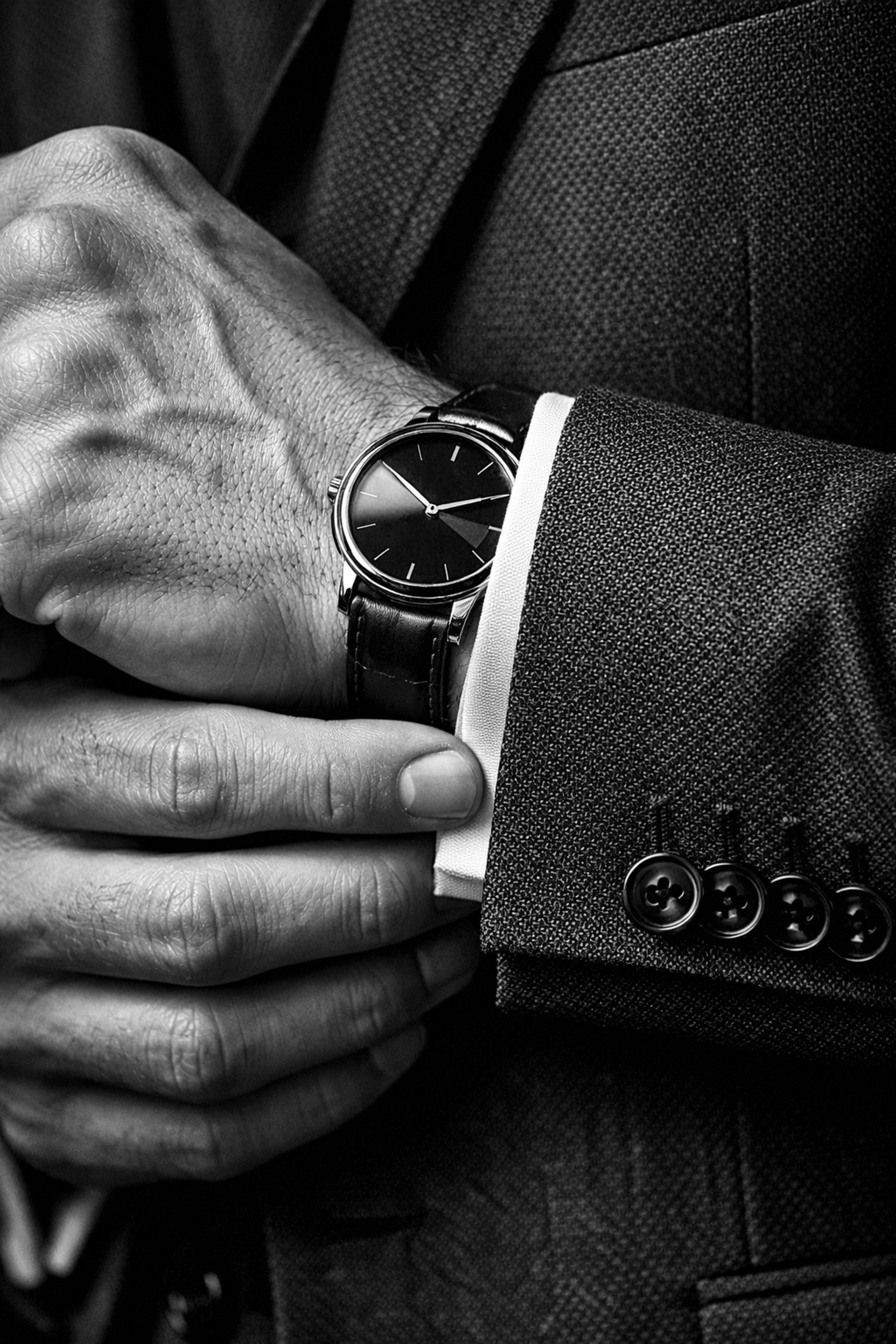 A well-groomed man adjusting his tailored blazer as part of a dating coach Sydney makeover.