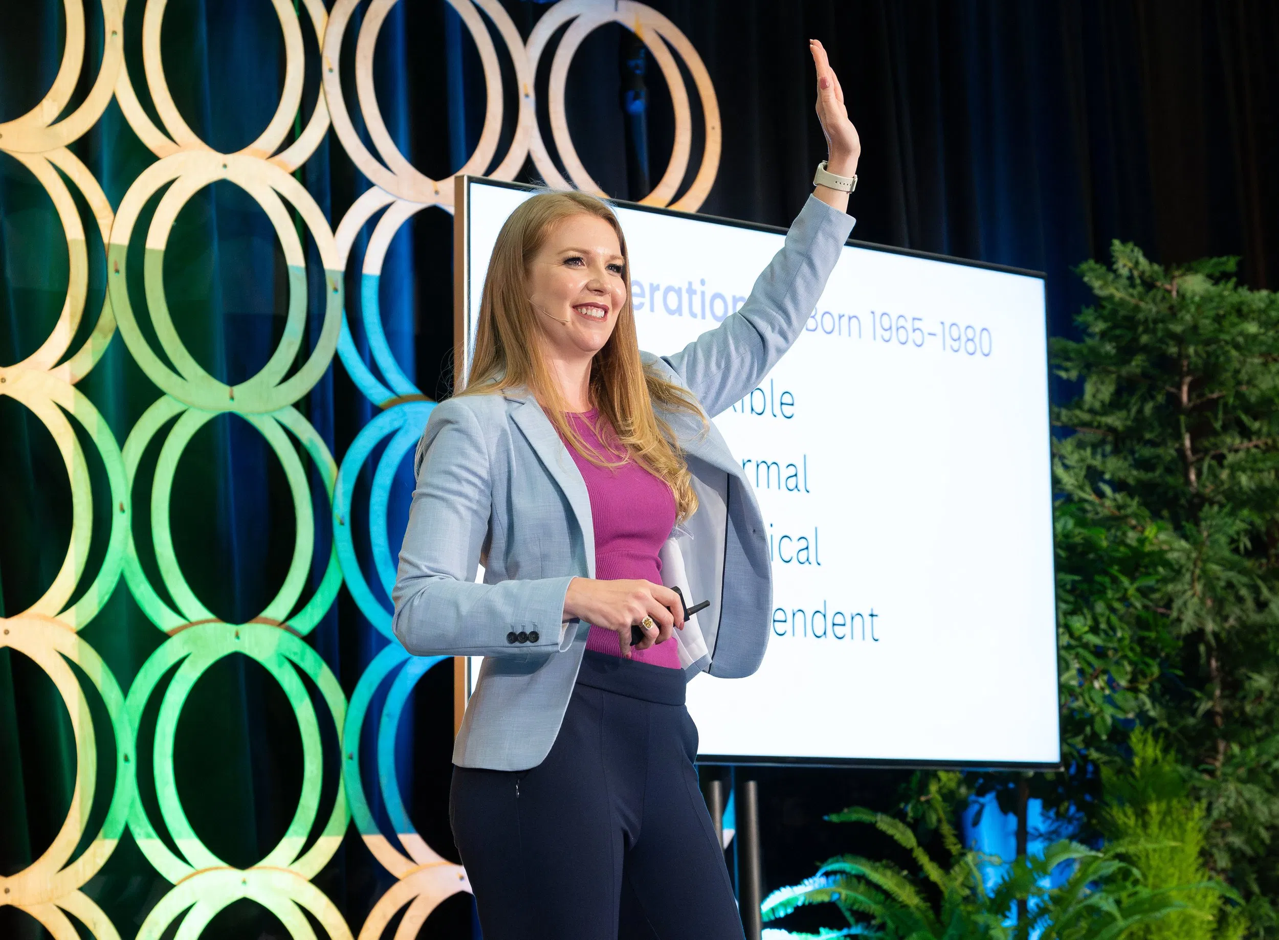 A professional presenter on stage delivering an energetic training session, representing Blue Plate's commitment to dynamic communication.