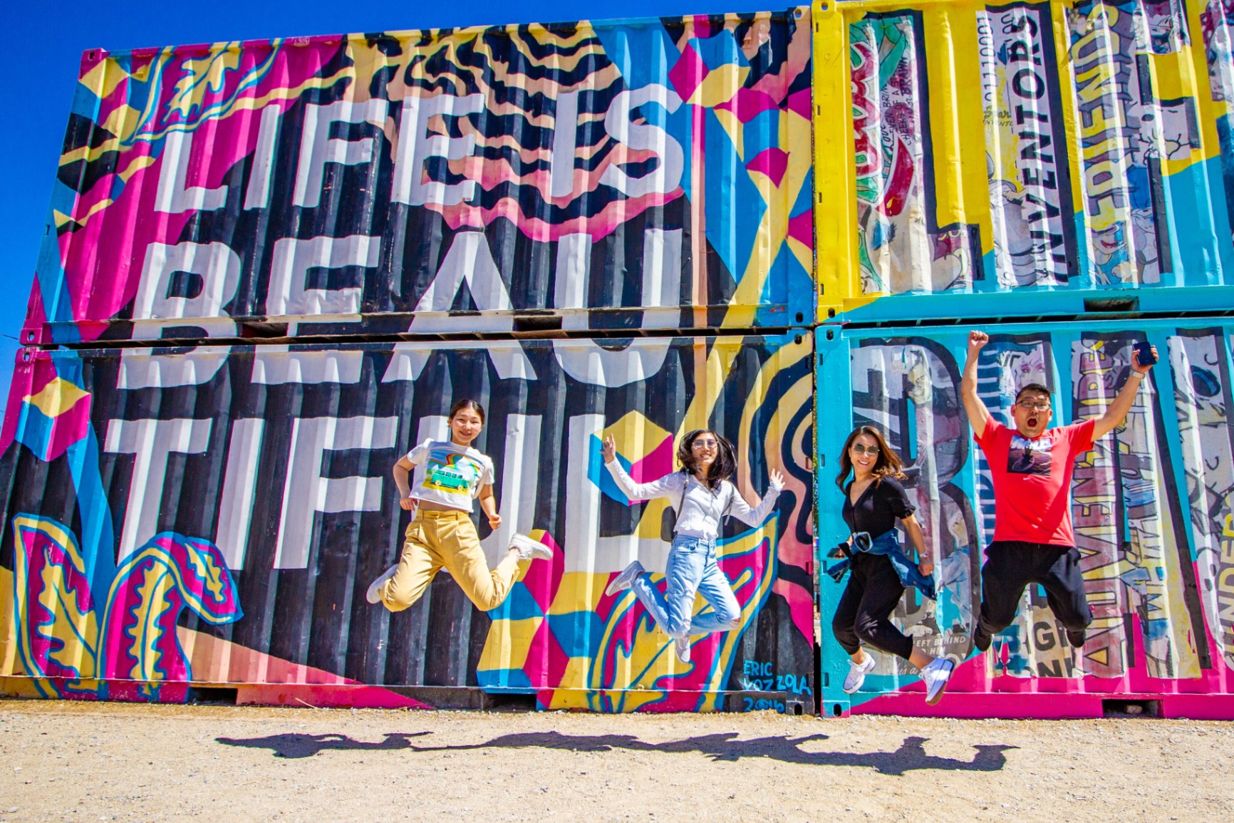 Group jumping in front of the Life is Beautiful mural in the Las Vegas Arts District