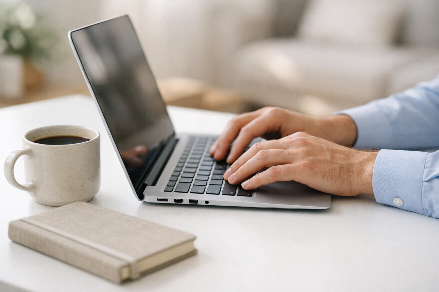 Landlord performing digital tenant screening and background checks on a laptop in a bright home office.