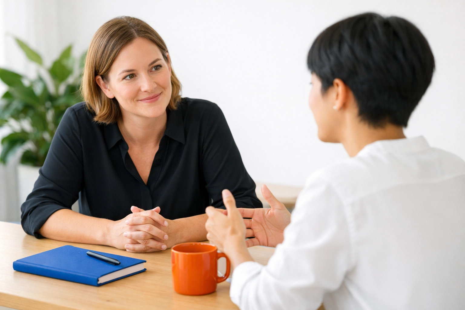 Two professionals in an ethical sales conversation, demonstrating non-pushy techniques in a minimalist office.