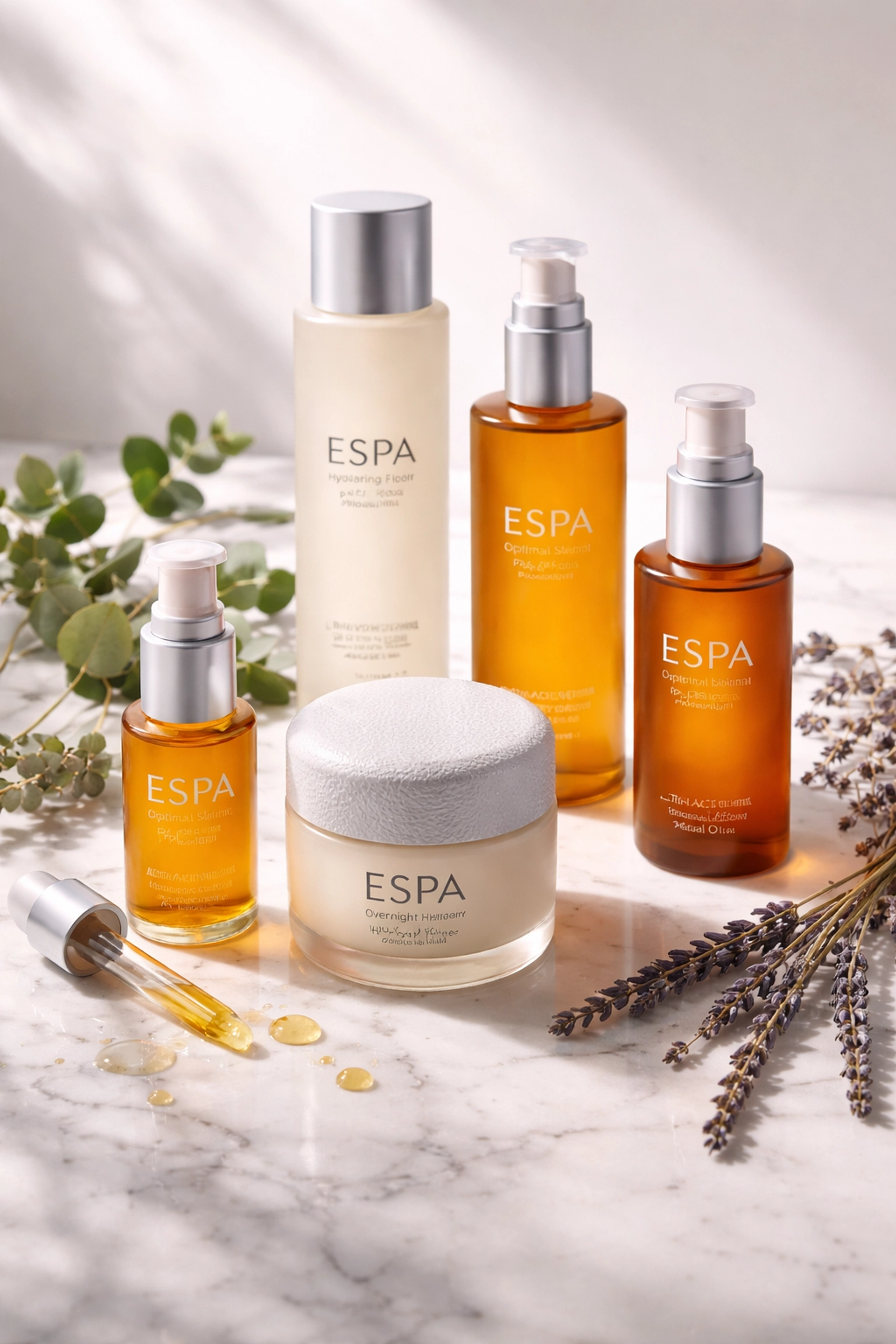 Luxury ESPA skincare bottles elegantly displayed with eucalyptus and lavender on marble, evoking a spa-like atmosphere