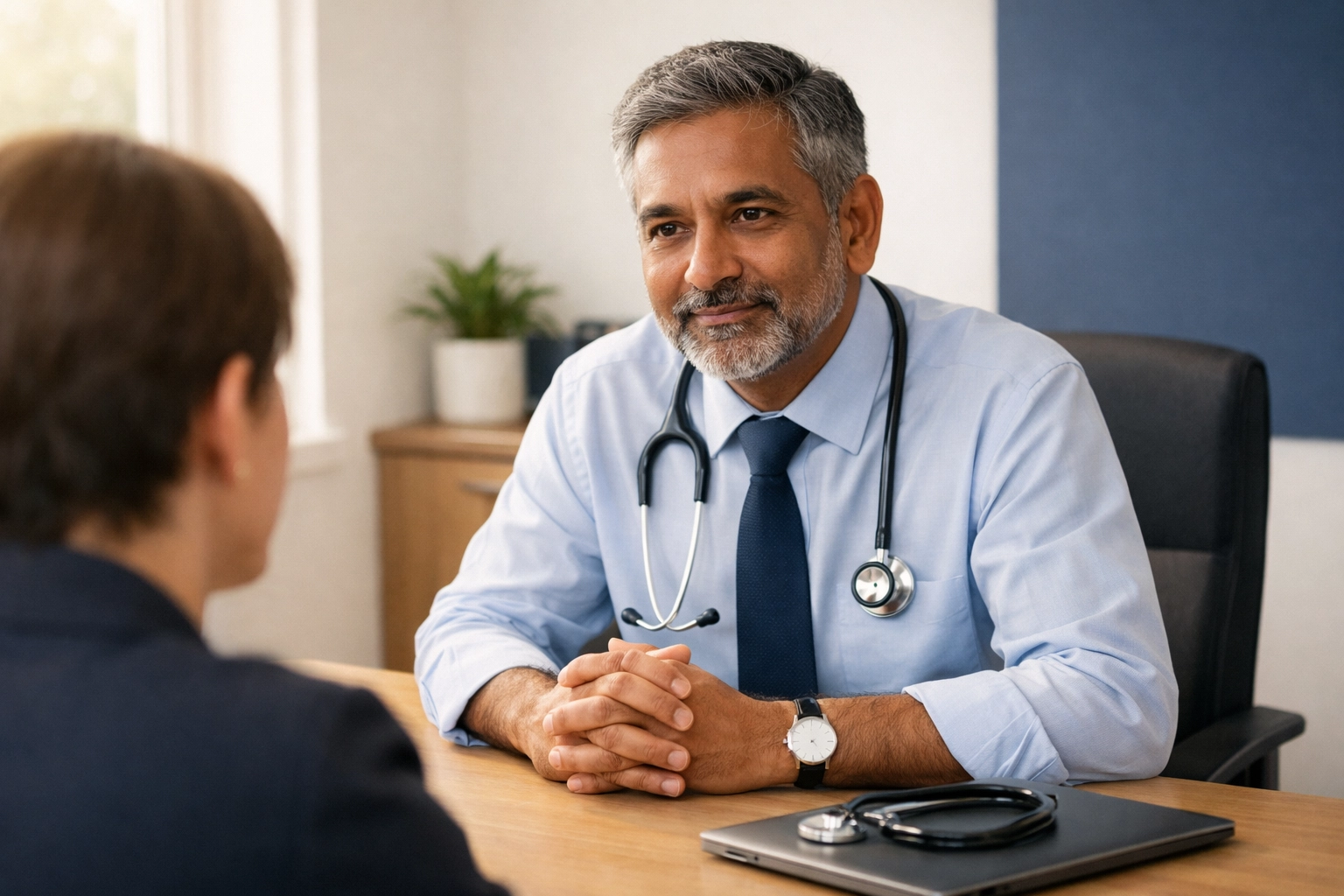 Consultant physician listening attentively to patient during medical history consultation