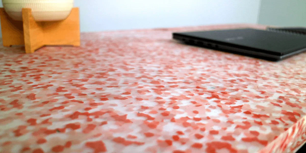 Close-up of a desk made from 100% recycled Australian plastic with a terrazzo-style pattern
